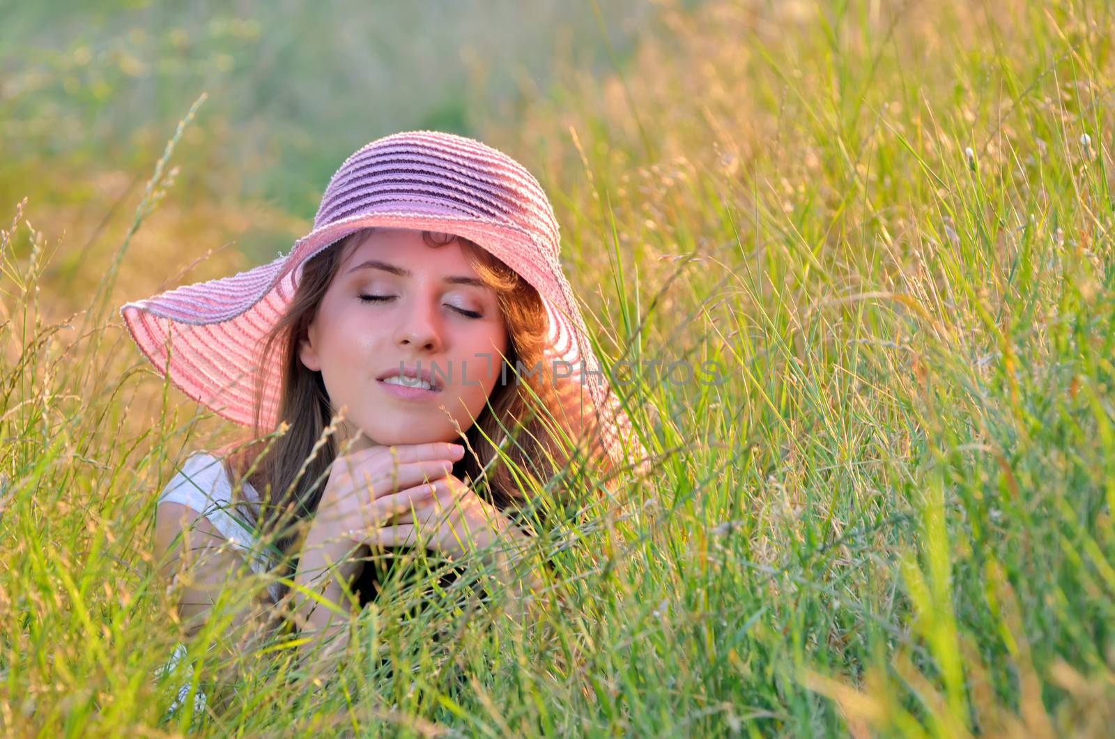 girl lies among the wild flowers in summer time