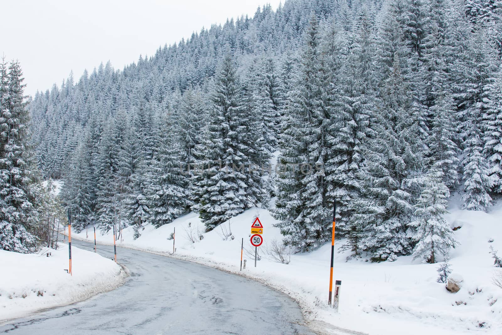 Road through snowy mountains by maxoliki