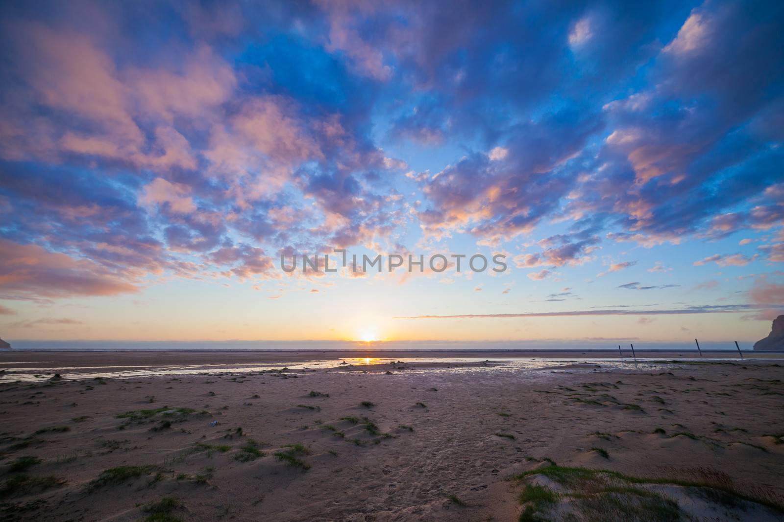 Sunset at the white beach at Iceland ocean coast. Panorama.