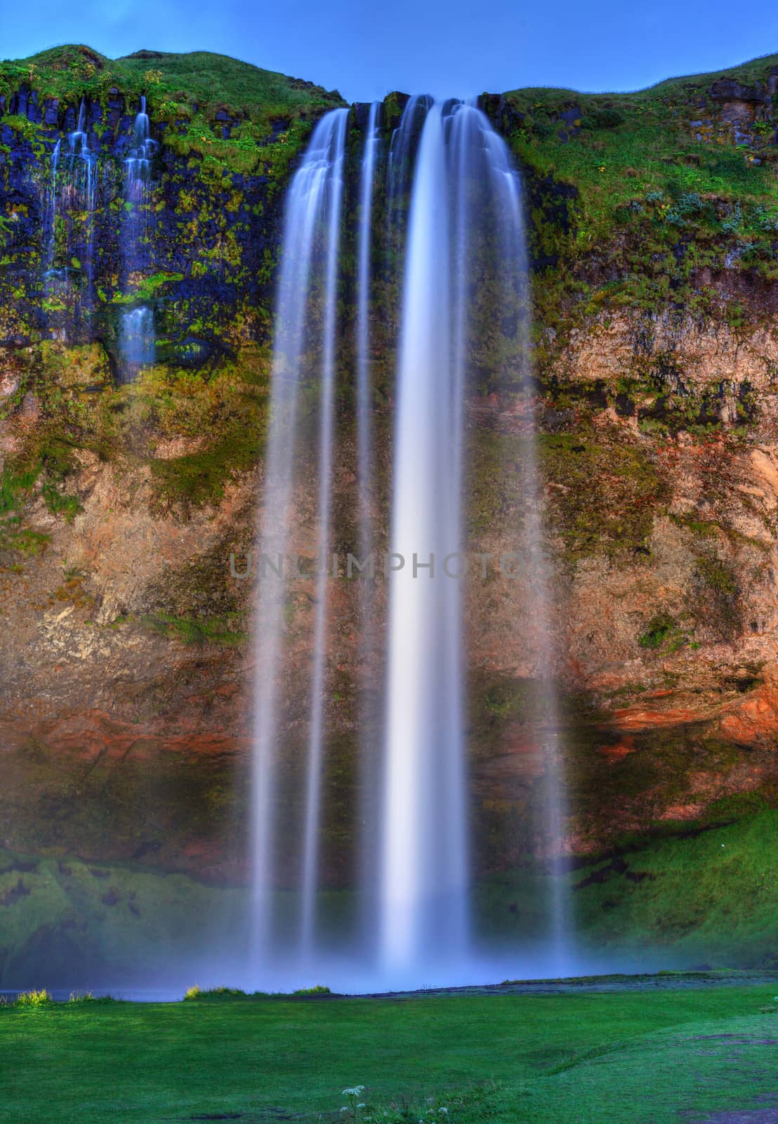 Seljalandfoss waterfall at sunset, Iceland. Horizontal shot.