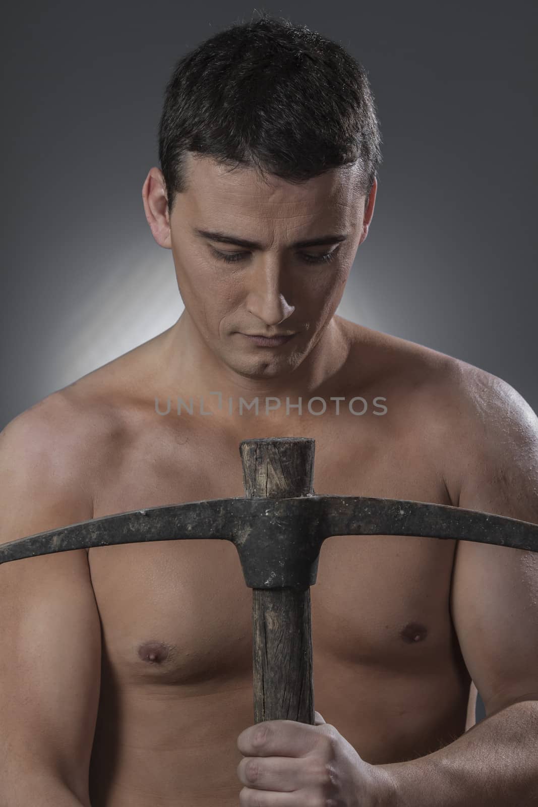 Construction worker portrait holding a peak. by FernandoCortes