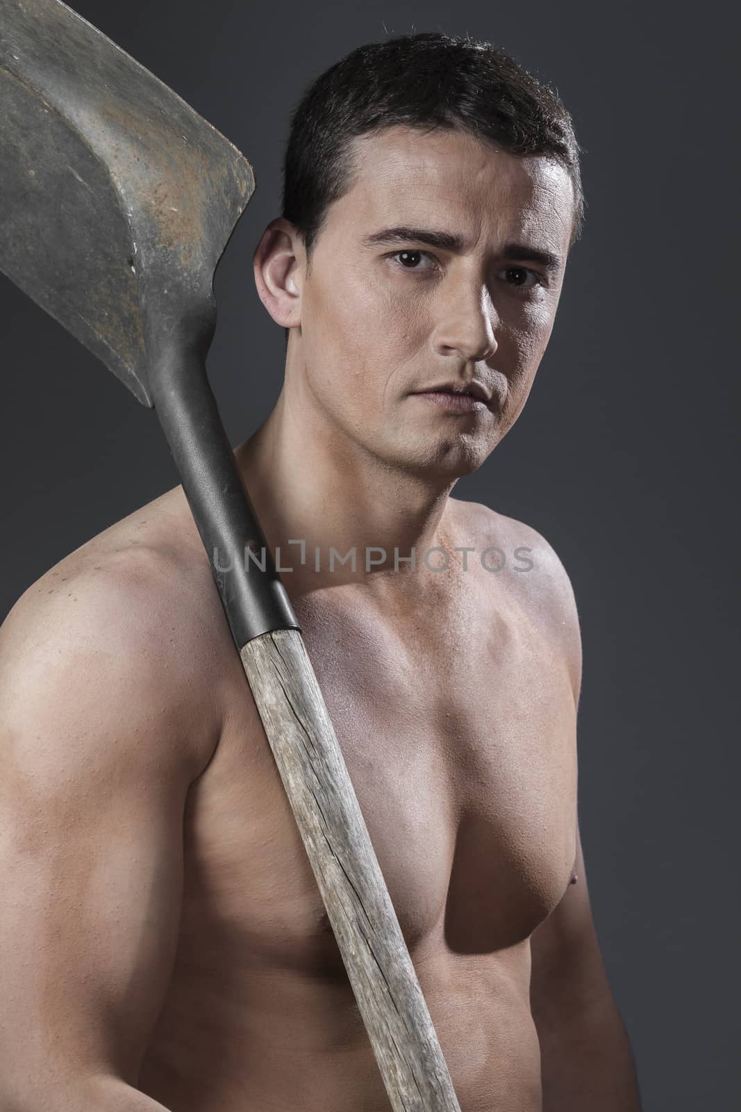 Builder.Male worker holding a shovel, sexy builder by FernandoCortes