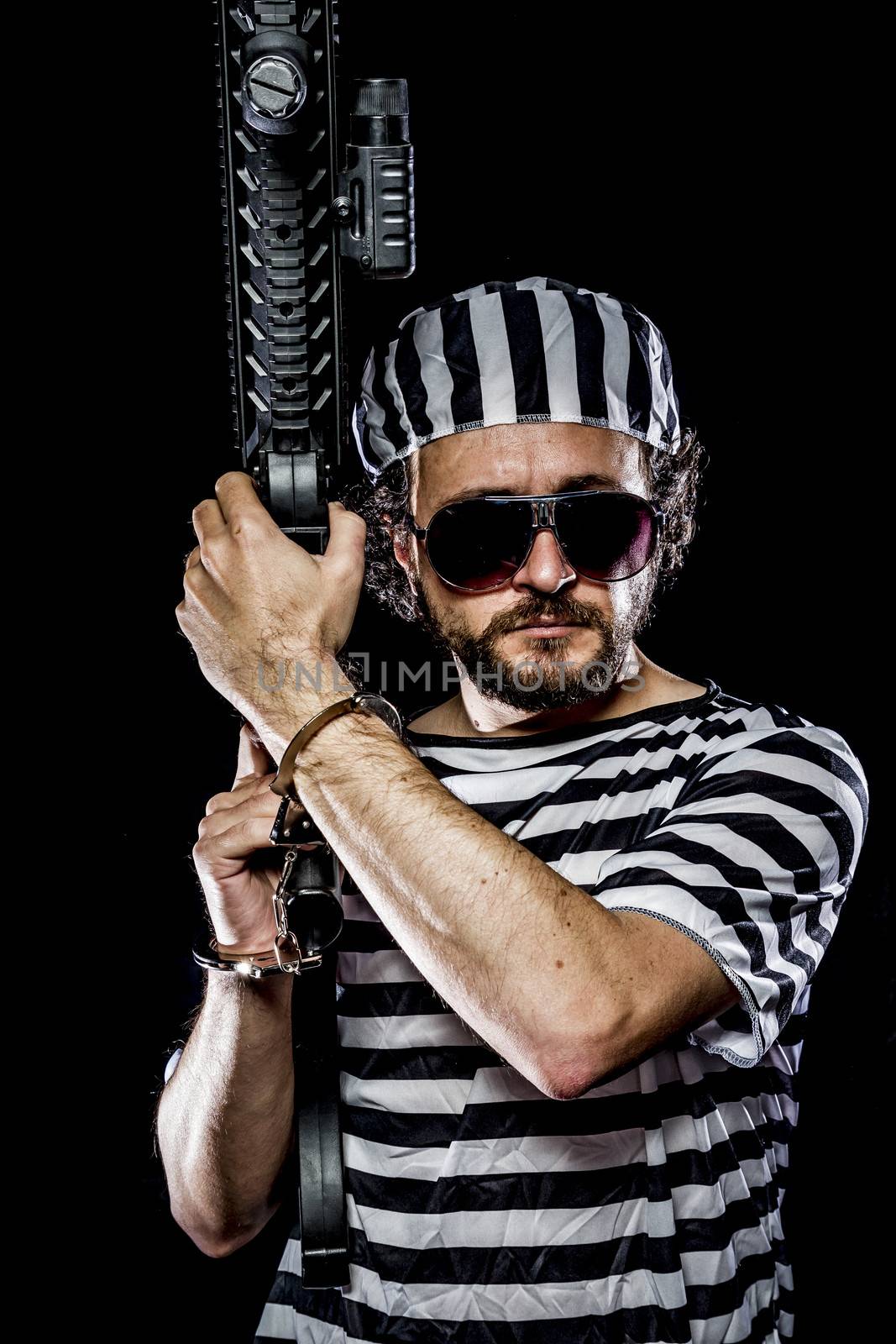 Security.Prison riot concept. Man holding a machine gun, prisone by FernandoCortes