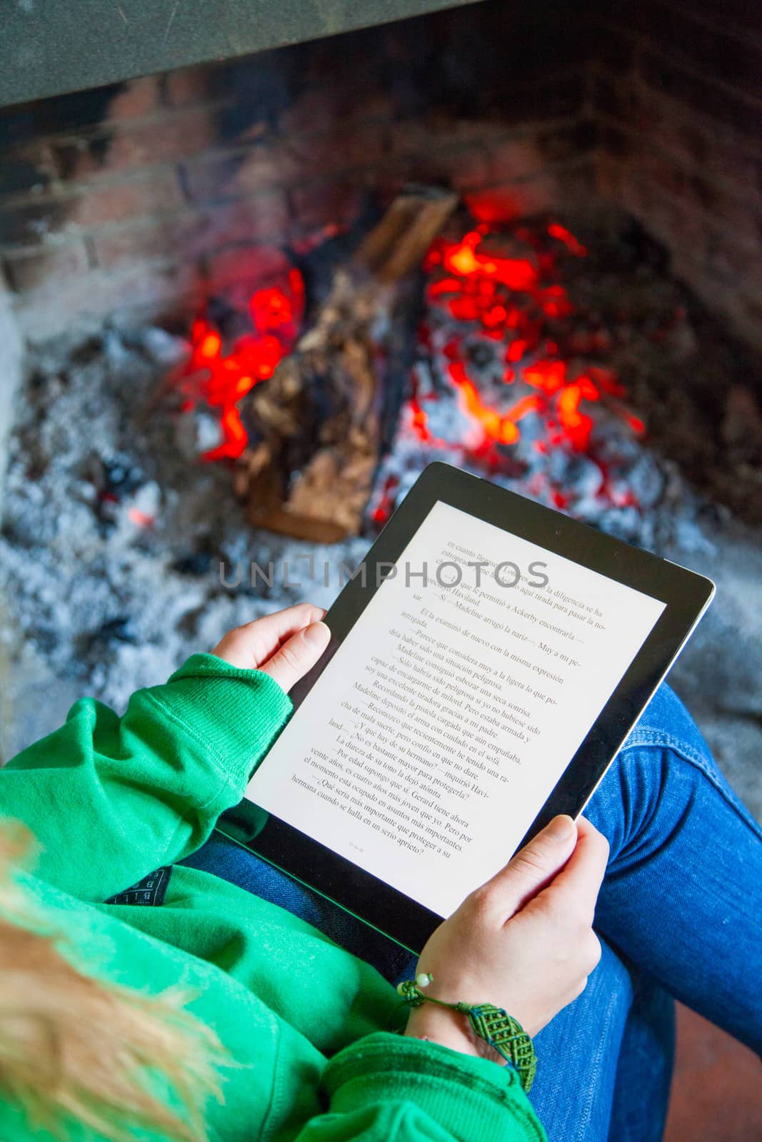 Reading book on digital tablet by Caracarafoto