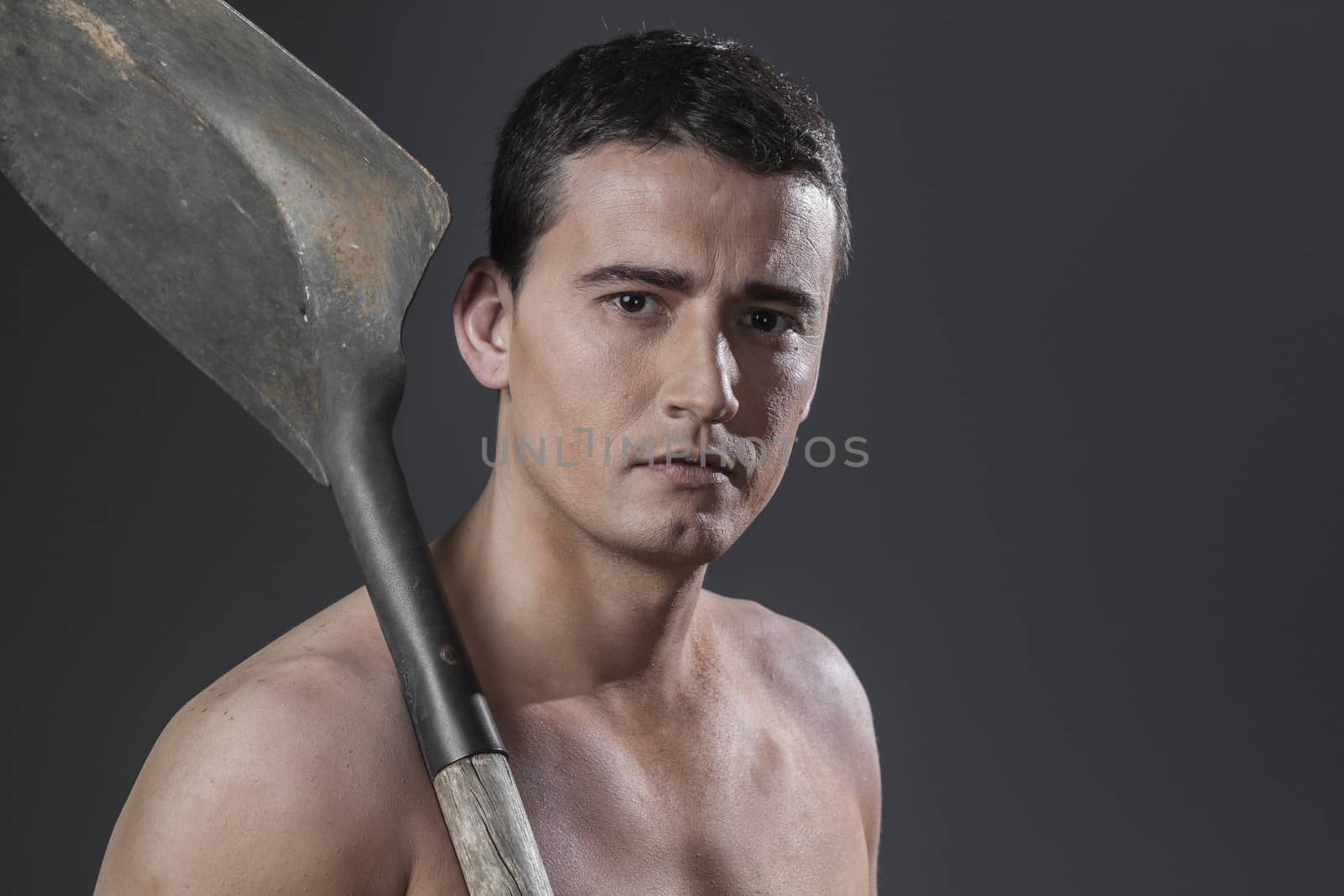 Safety, Male worker holding a shovel, sexy builder