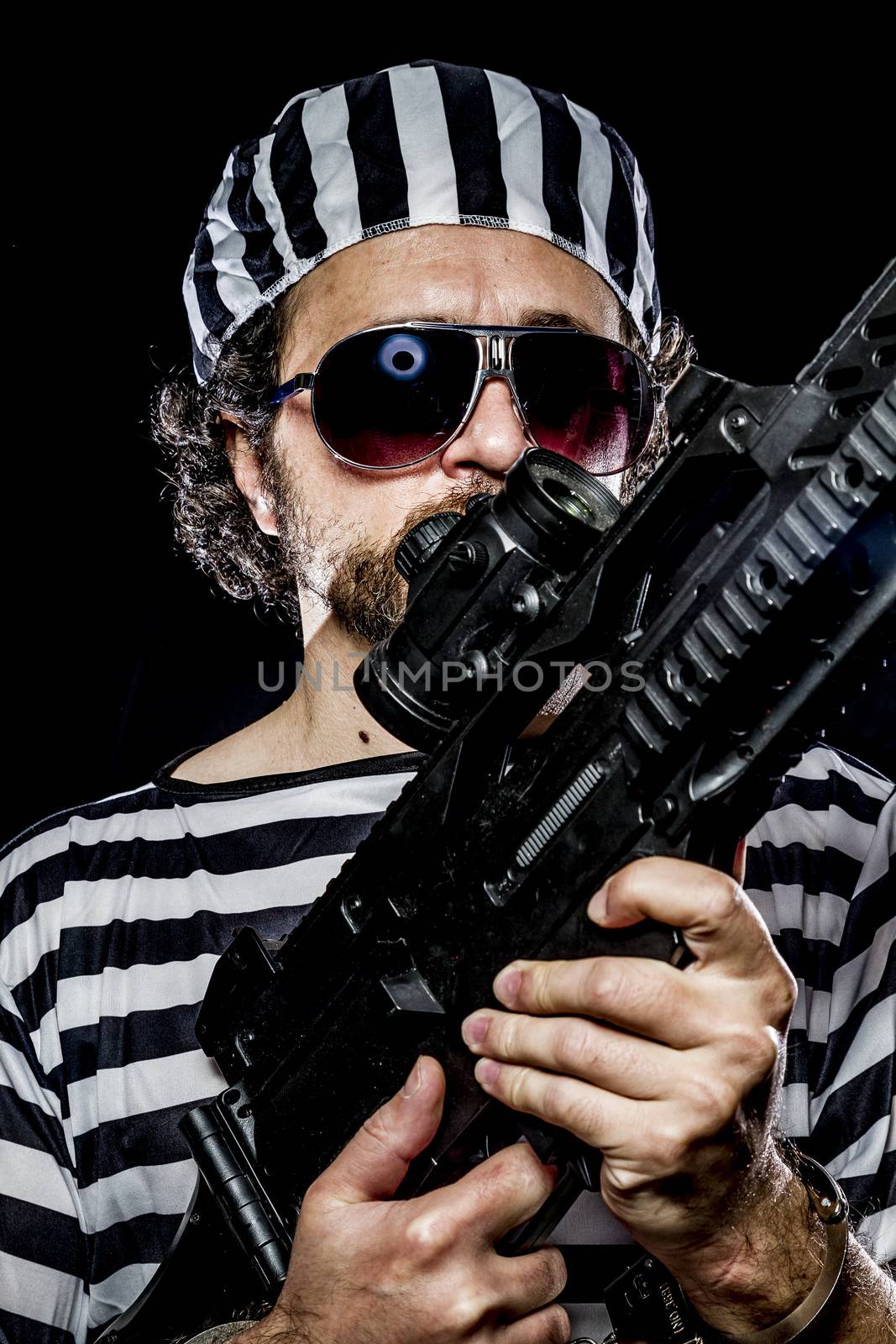 Opposition, Prison riot concept. Man holding a machine gun, prisoner