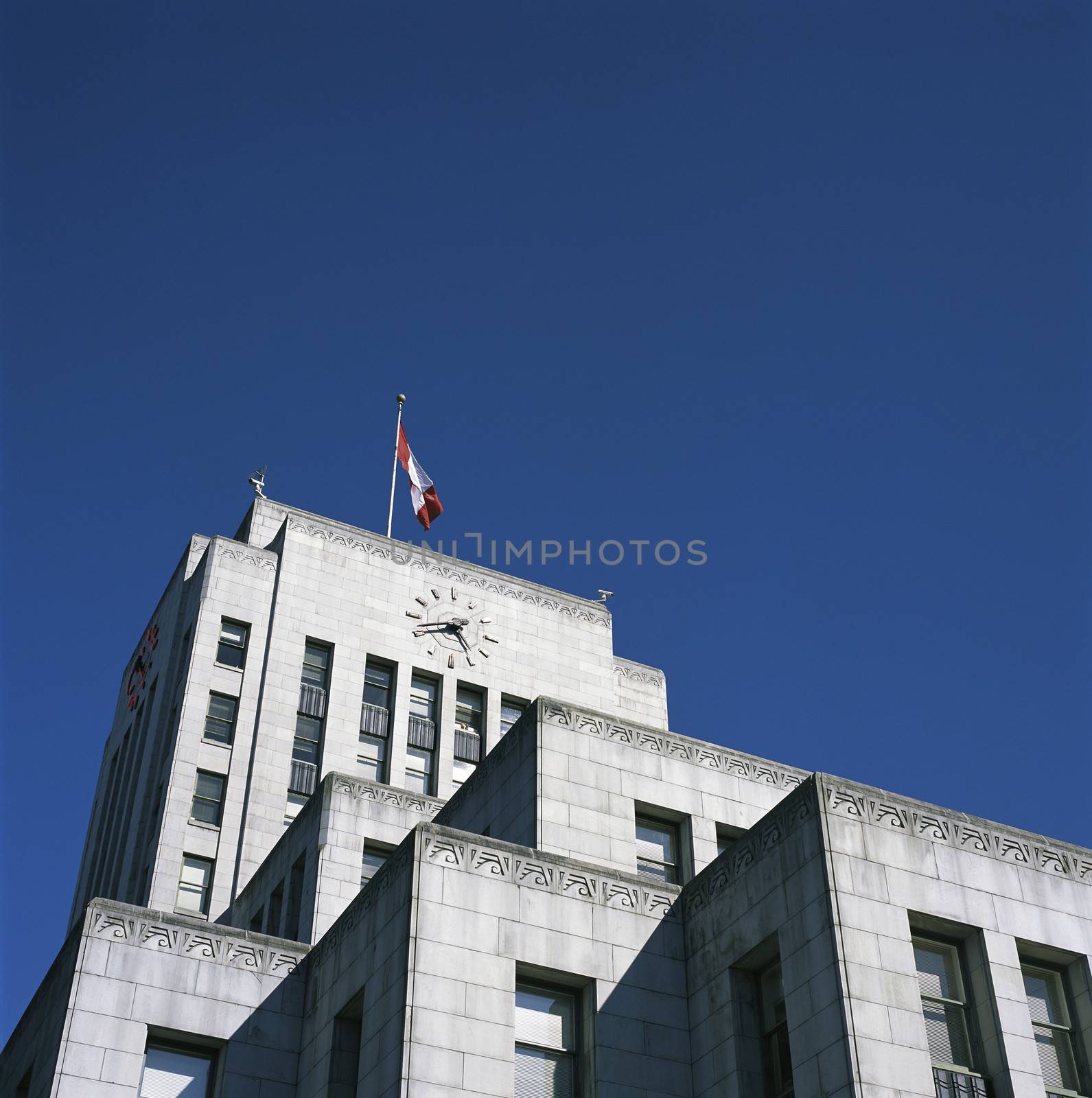 Large city hall building with canadian flag