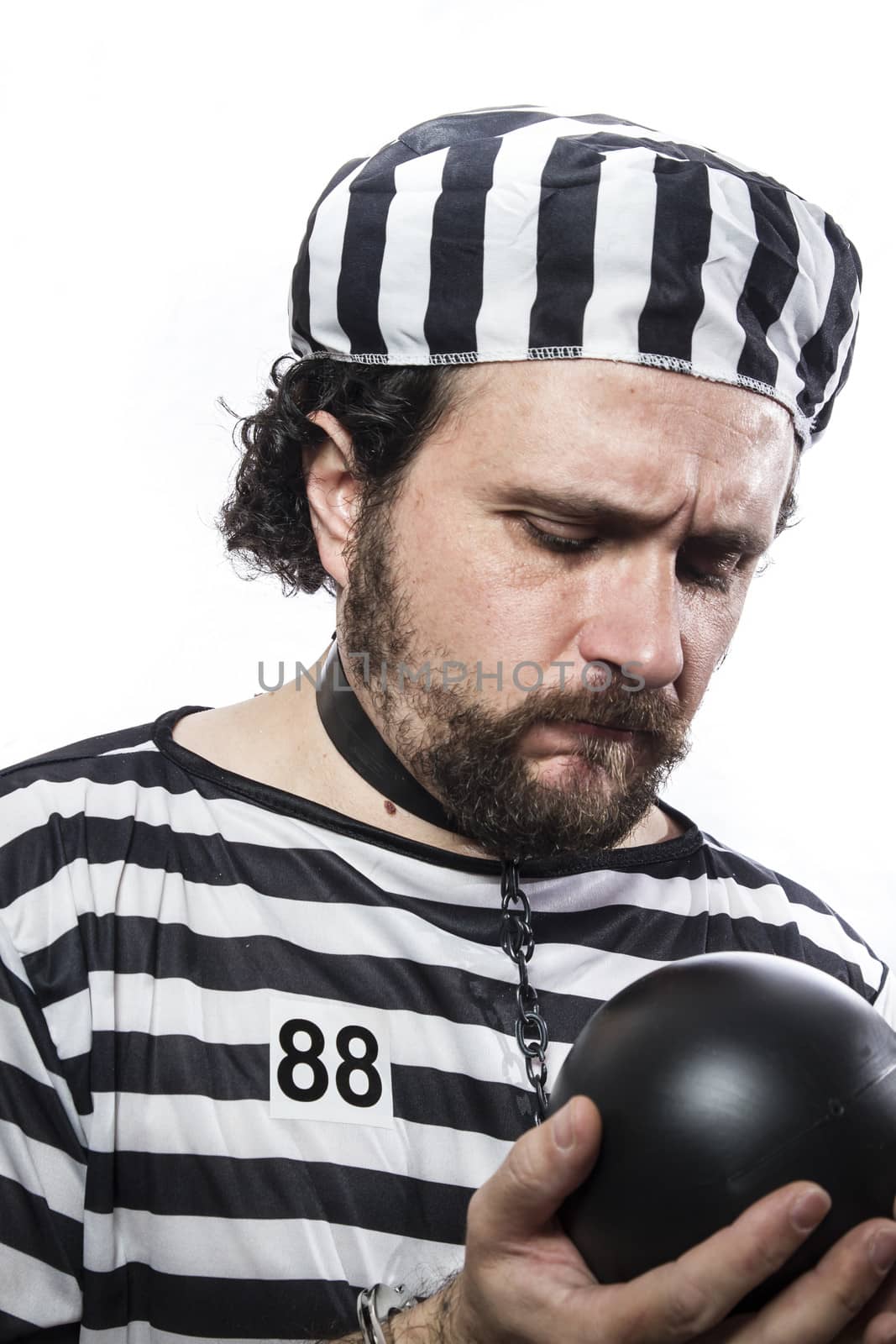 Punishment, one caucasian man prisoner criminal with chain ball and handcuffs in studio isolated on white background