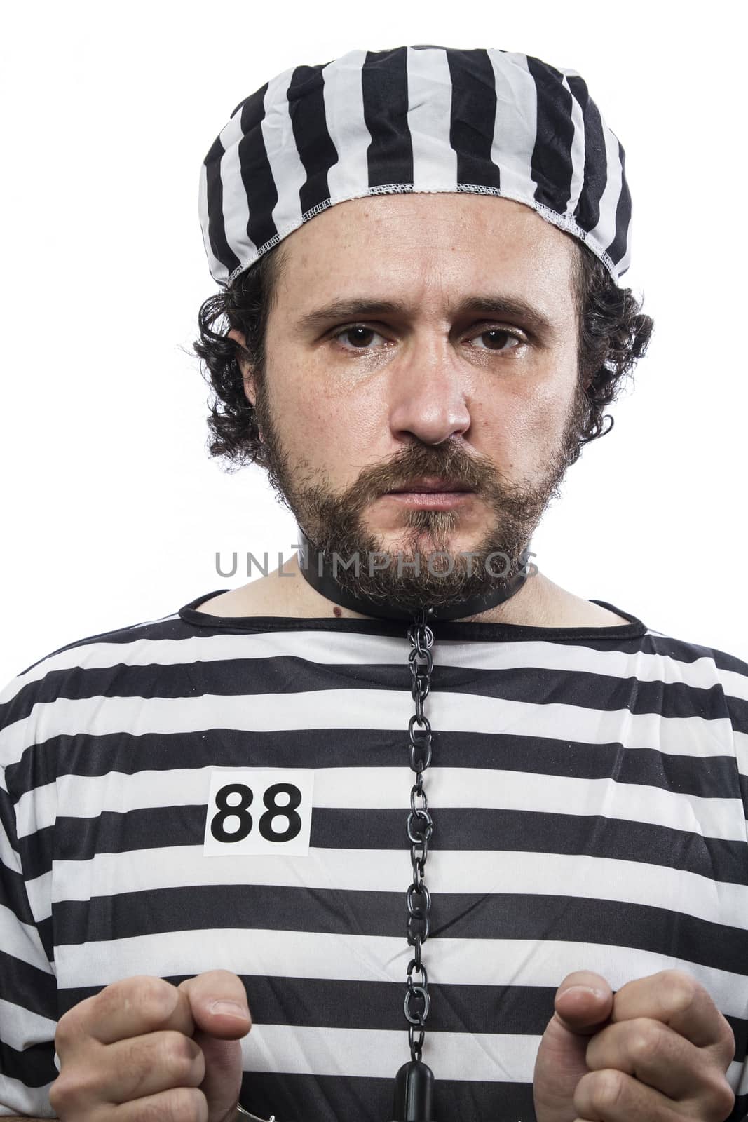 Trapped, one caucasian man prisoner criminal with chain ball and handcuffs in studio isolated on white background
