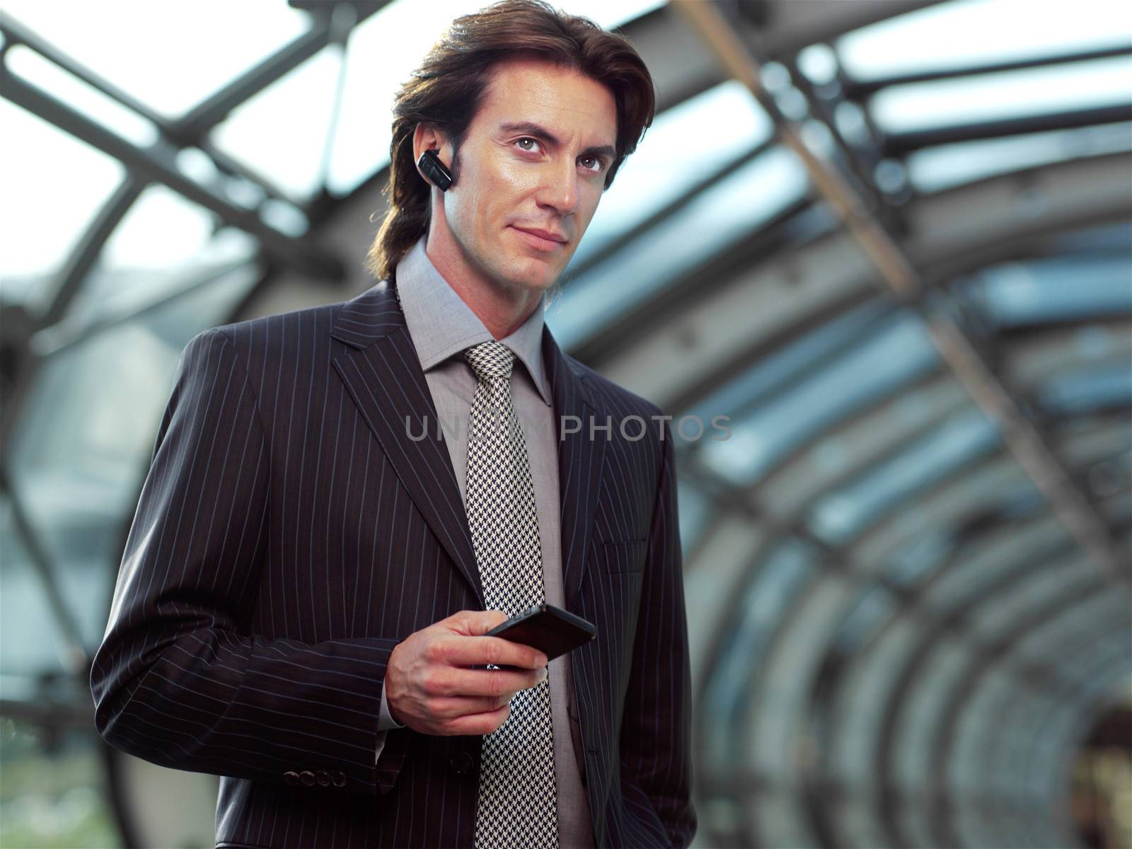 Businessman with mobile phone in airport