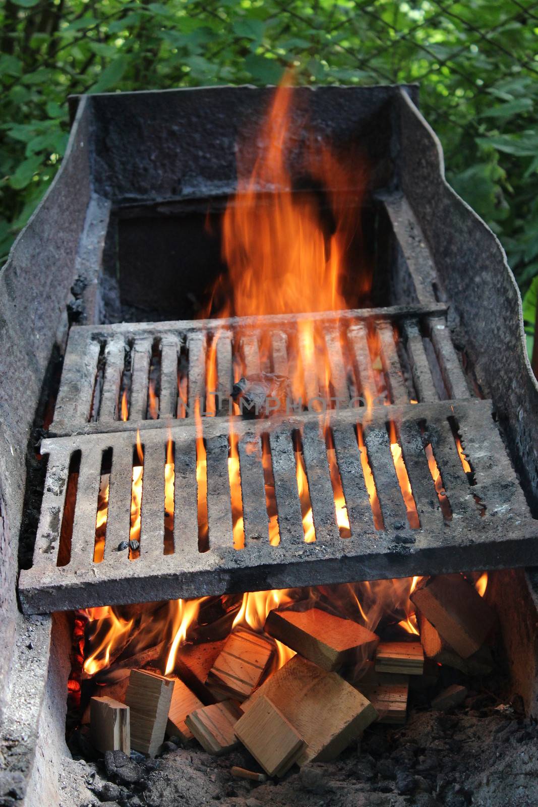 big brazier with burning fire prepared for cooking