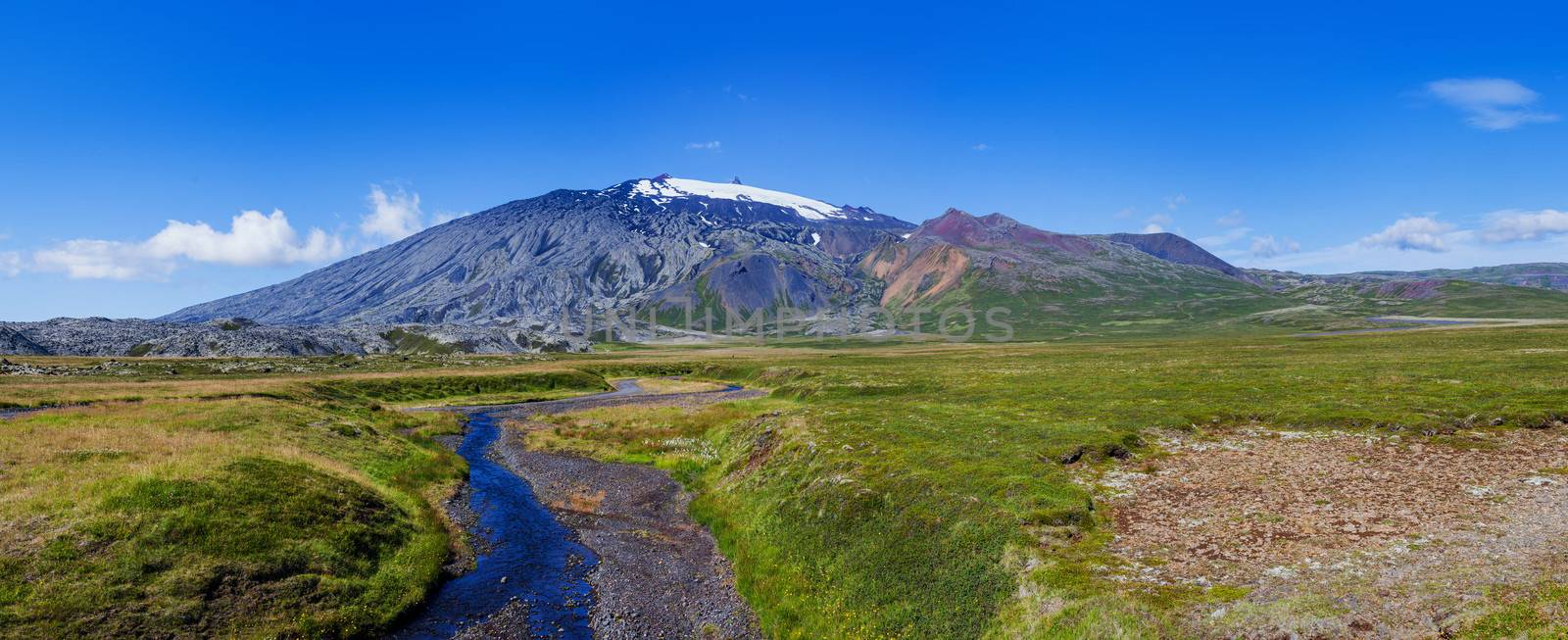 Summer Iceland Landscape with River, Green Fields and Bright Blue Sky. Panorama