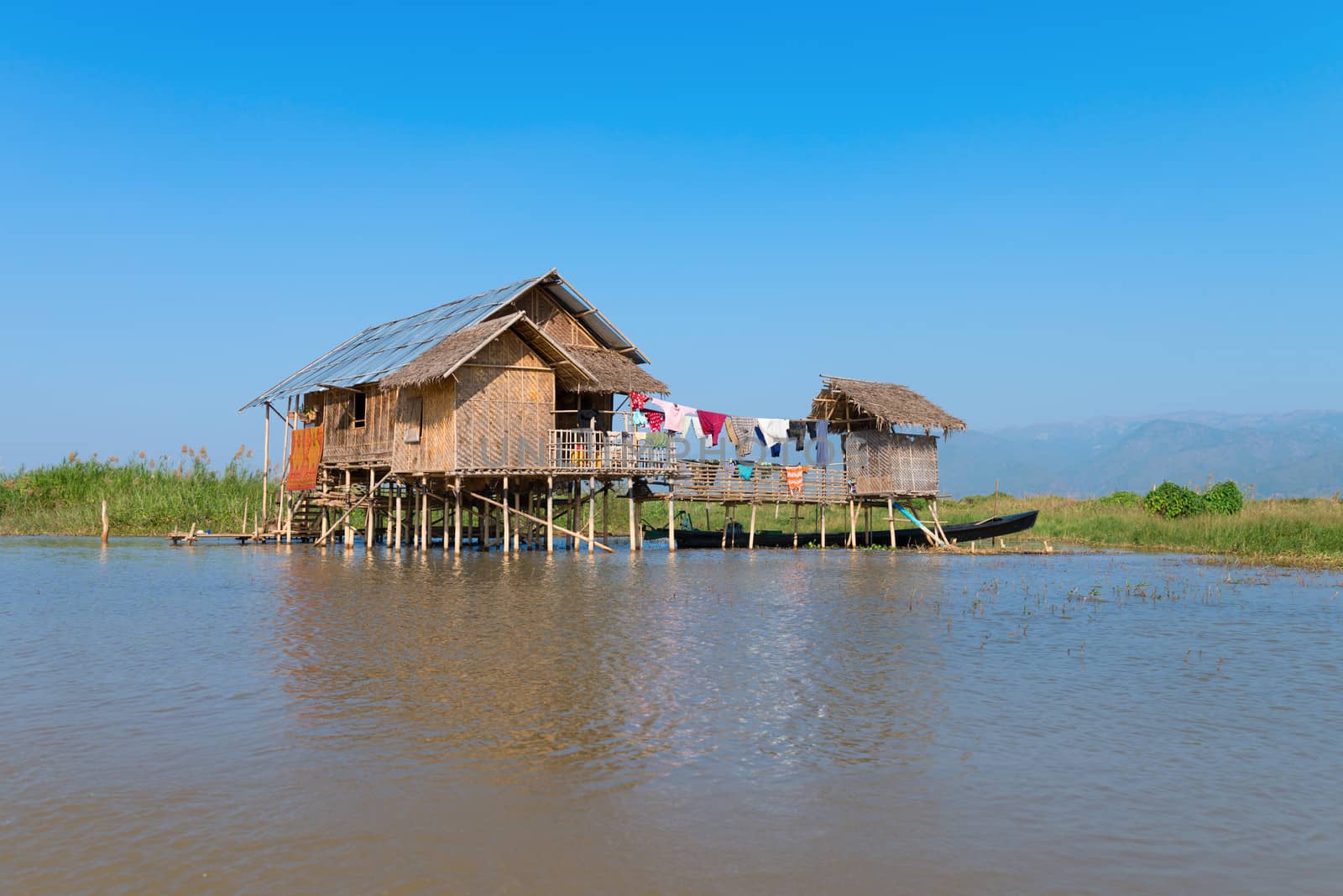 Traditional stilts wooden and bamboo house of Intha people in water on Inle lake, Myanmar (Burma) 