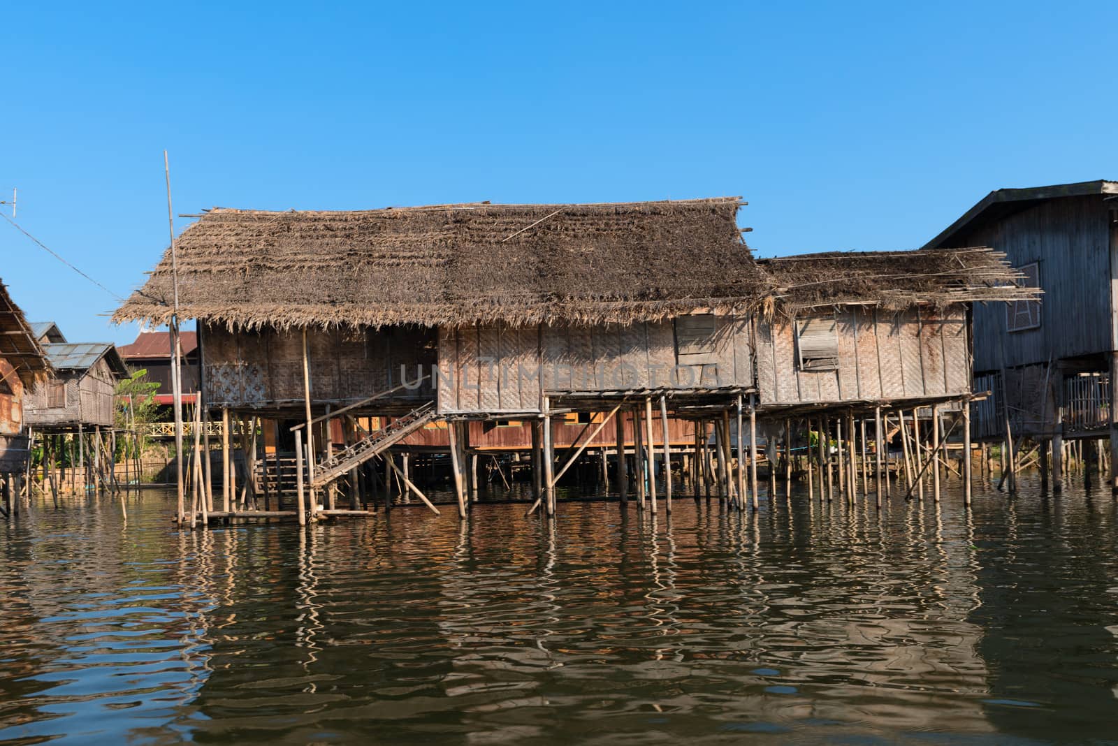 Traditional stilts wooden and bamboo house of Intha people in water on Inle lake, Myanmar (Burma) 