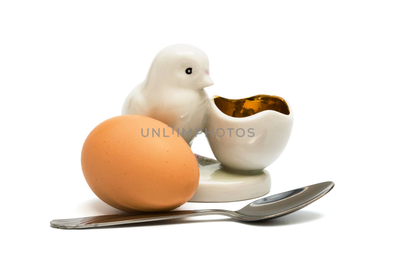 Egg and the spoon on a white background