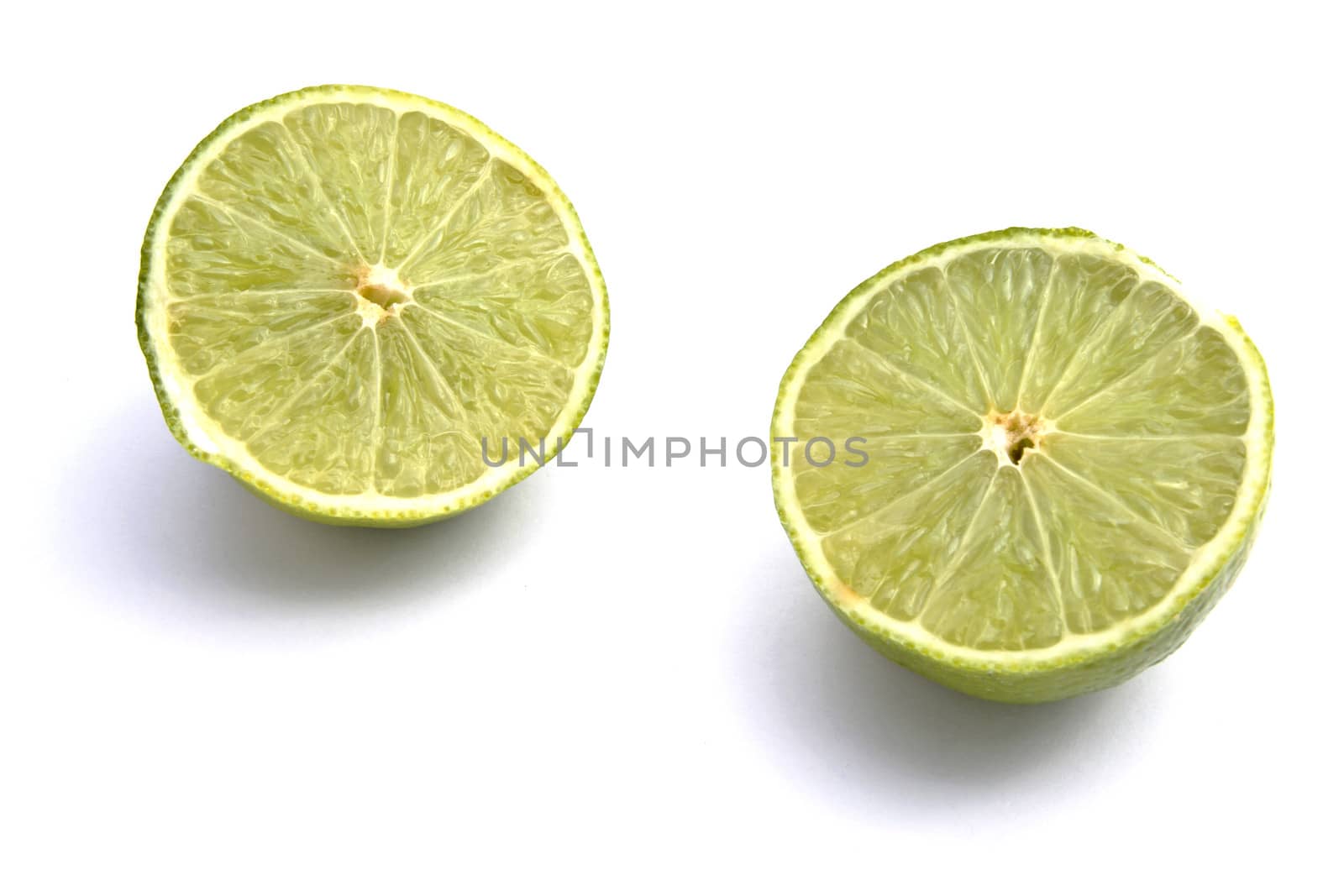 Fresh green lime closeup on white background
