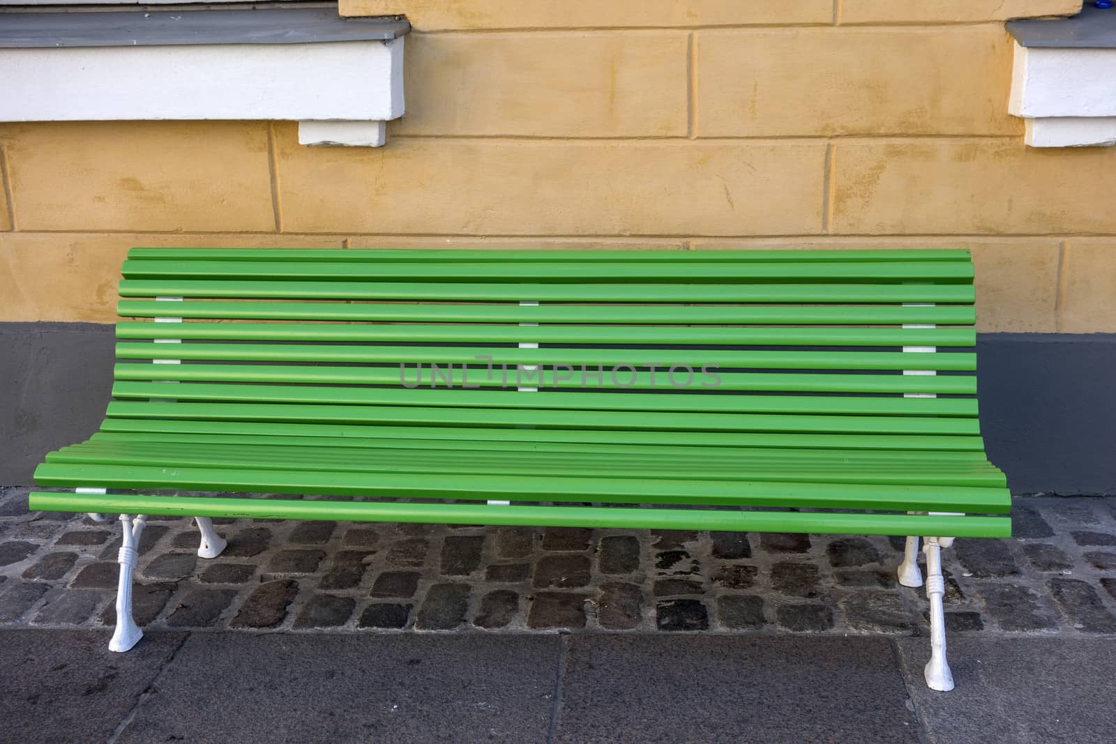 Green bench in the street