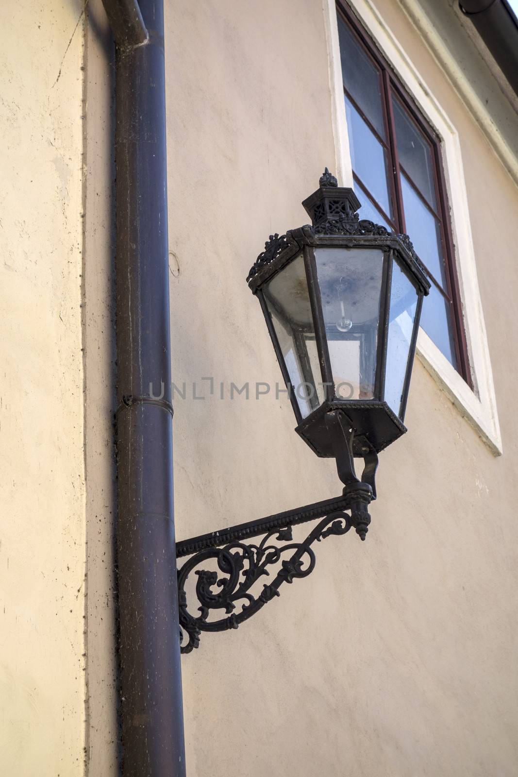 Old street light closeup on the wall 