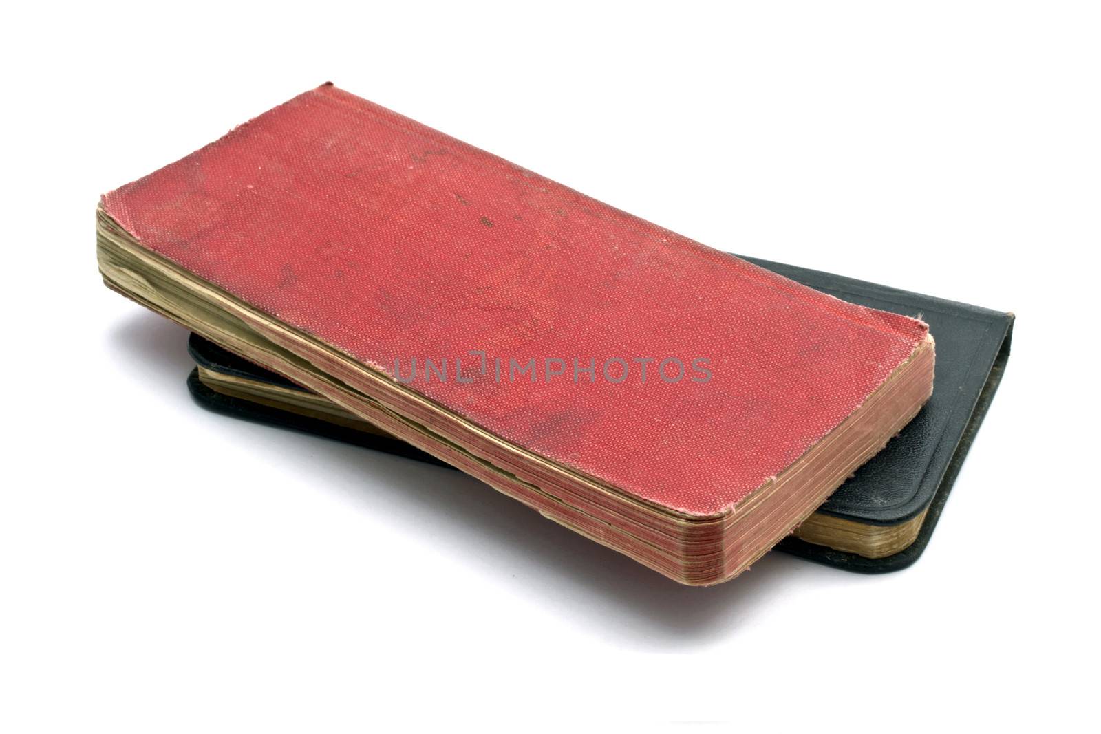 Red and black notebooks closeup on white