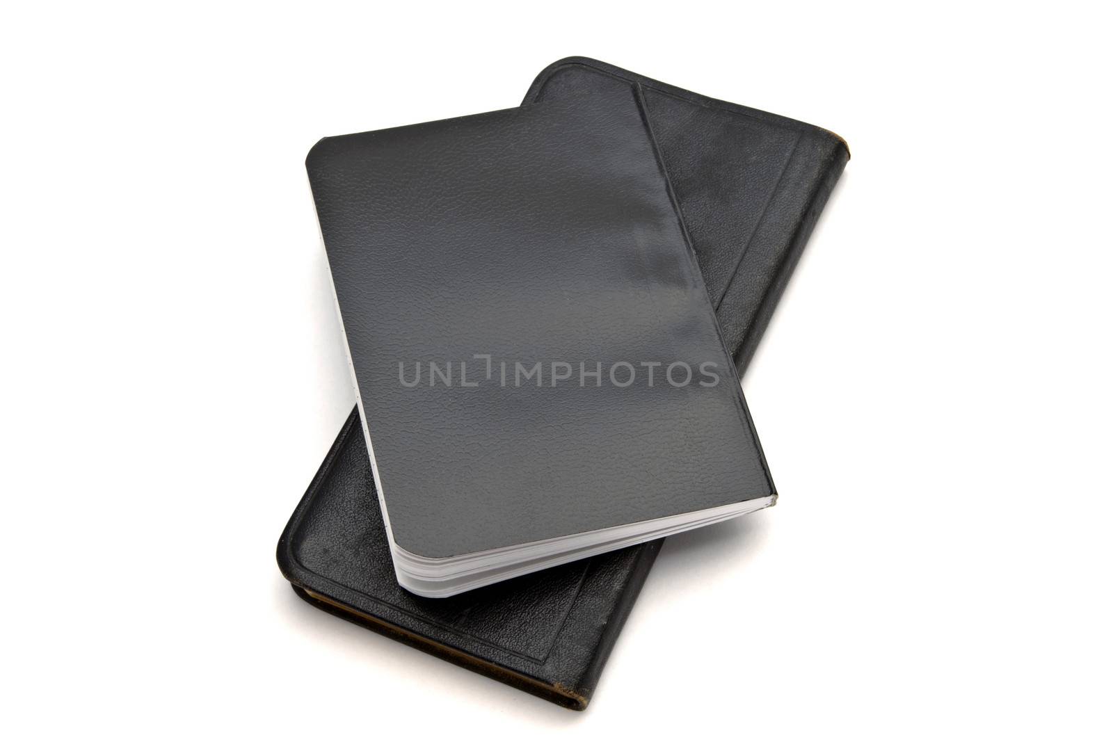 Black notebooks closeup on white background