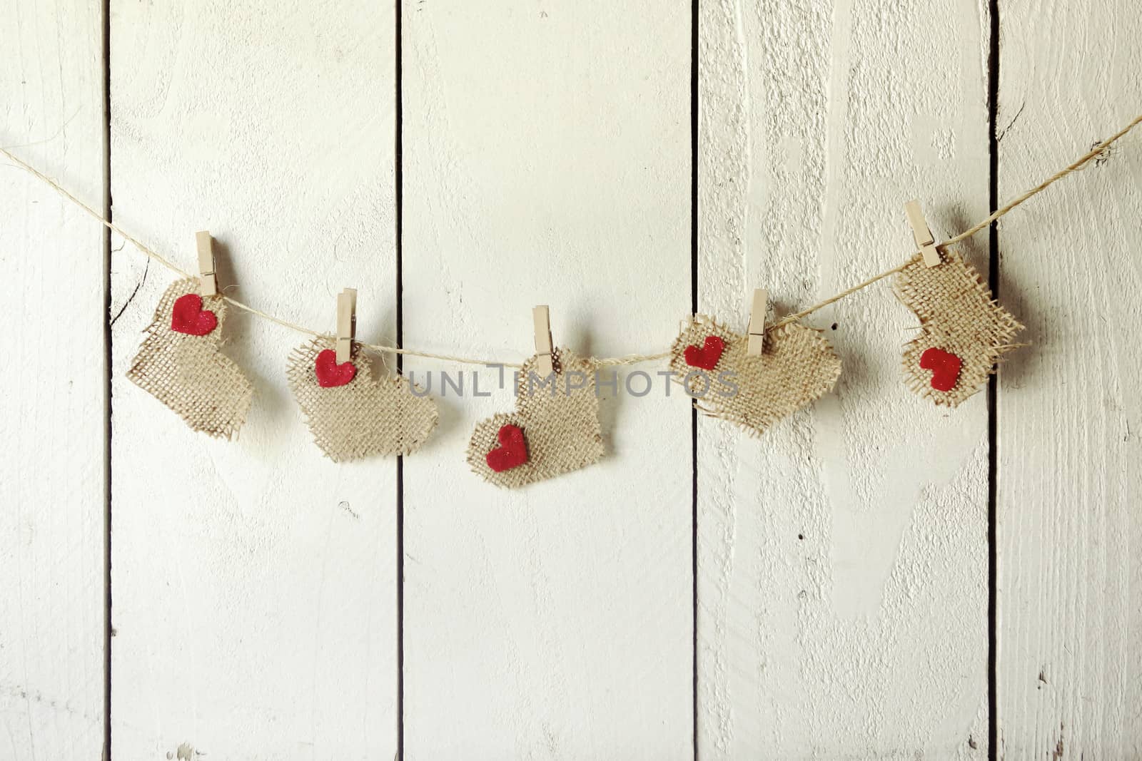 Bright Valentine Burlap Hearts Hanging on a Wood Wall