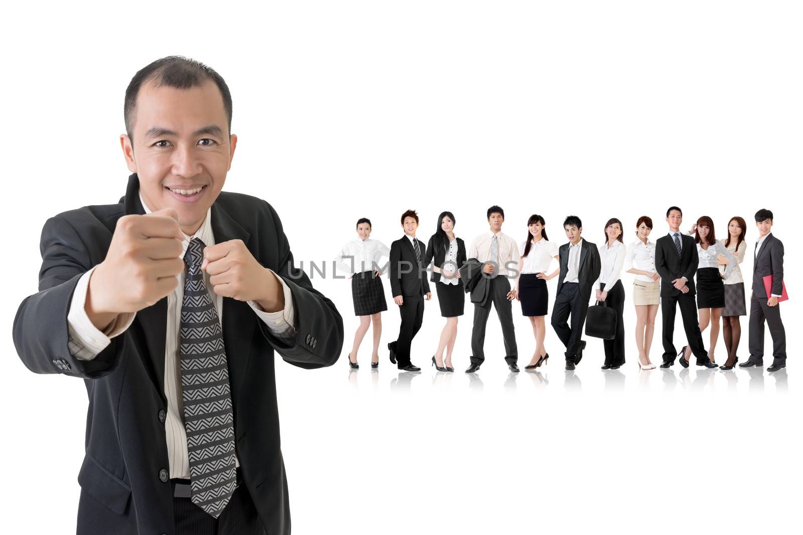 Confident businessman fighting and standing in front of his team on studio white background.
