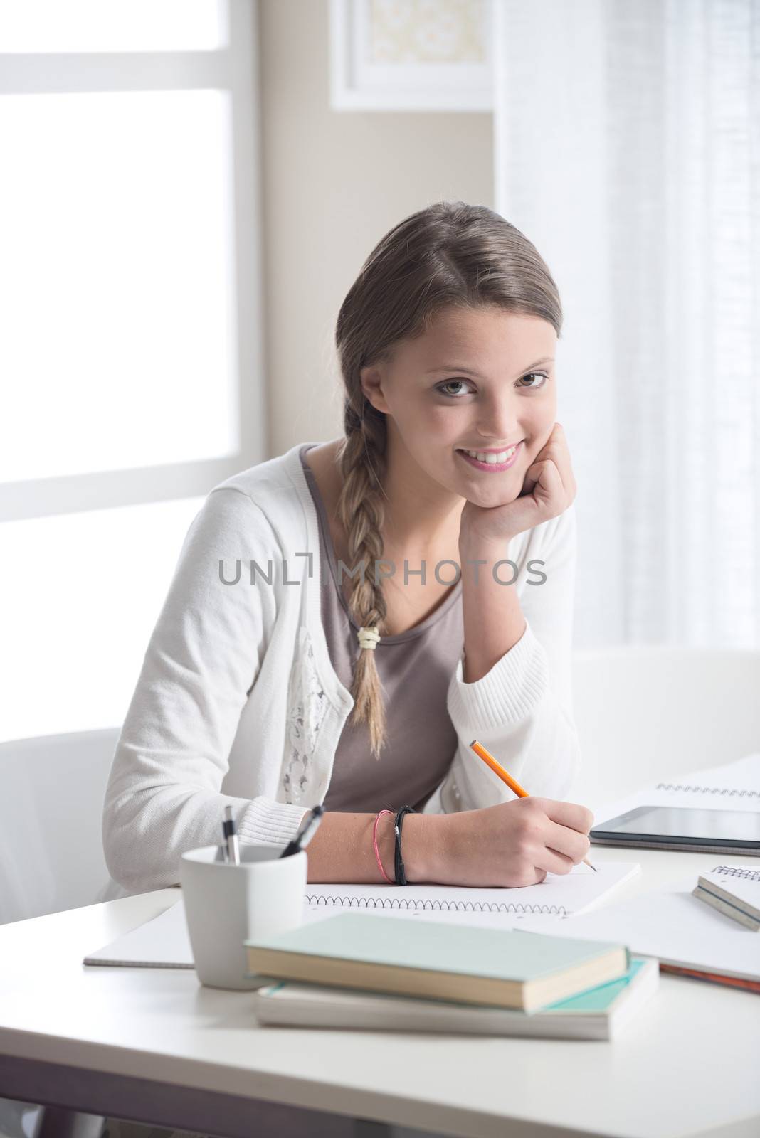 Portrait of a beautiful girl studying at home