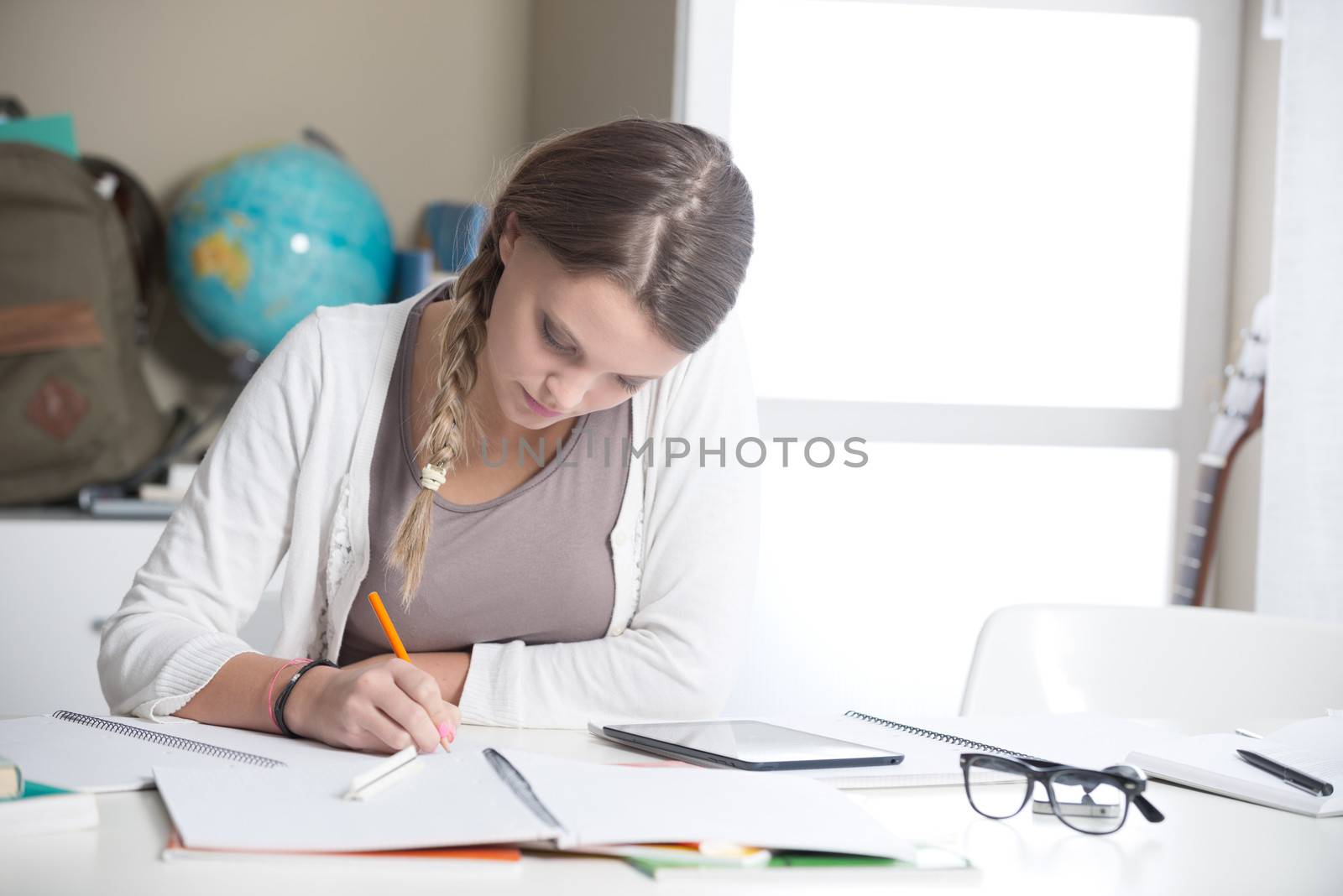 Portrait of a beautiful girl studying at home