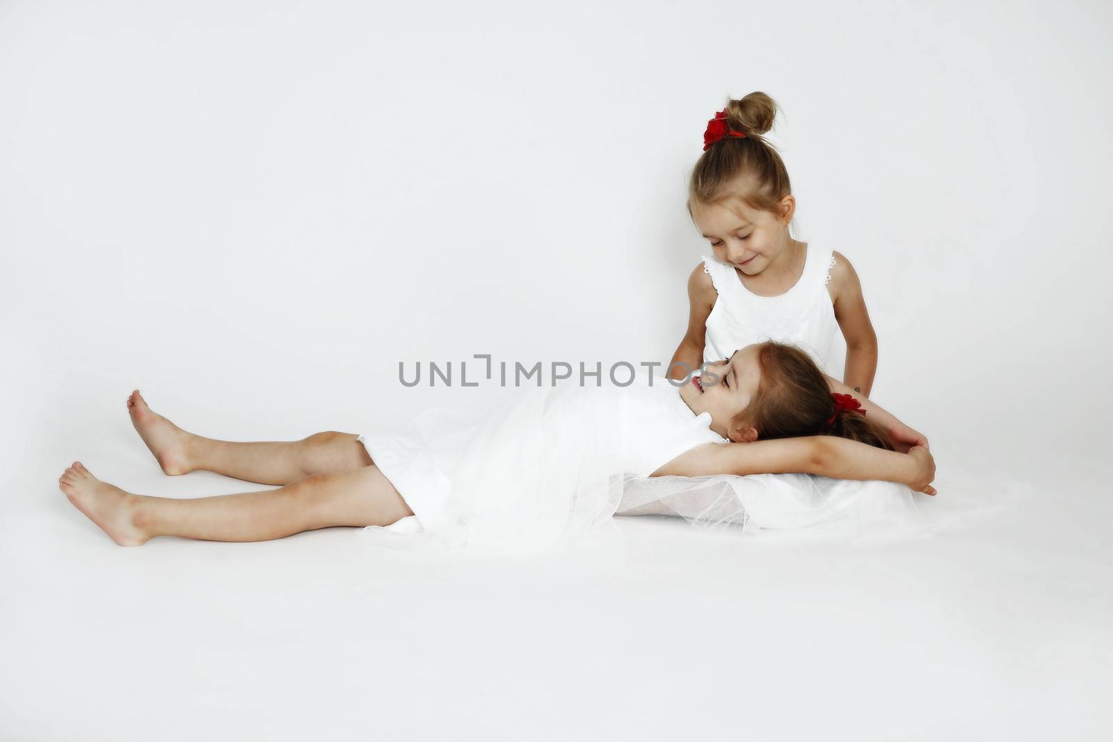 Young girls in the studio. White dresses.