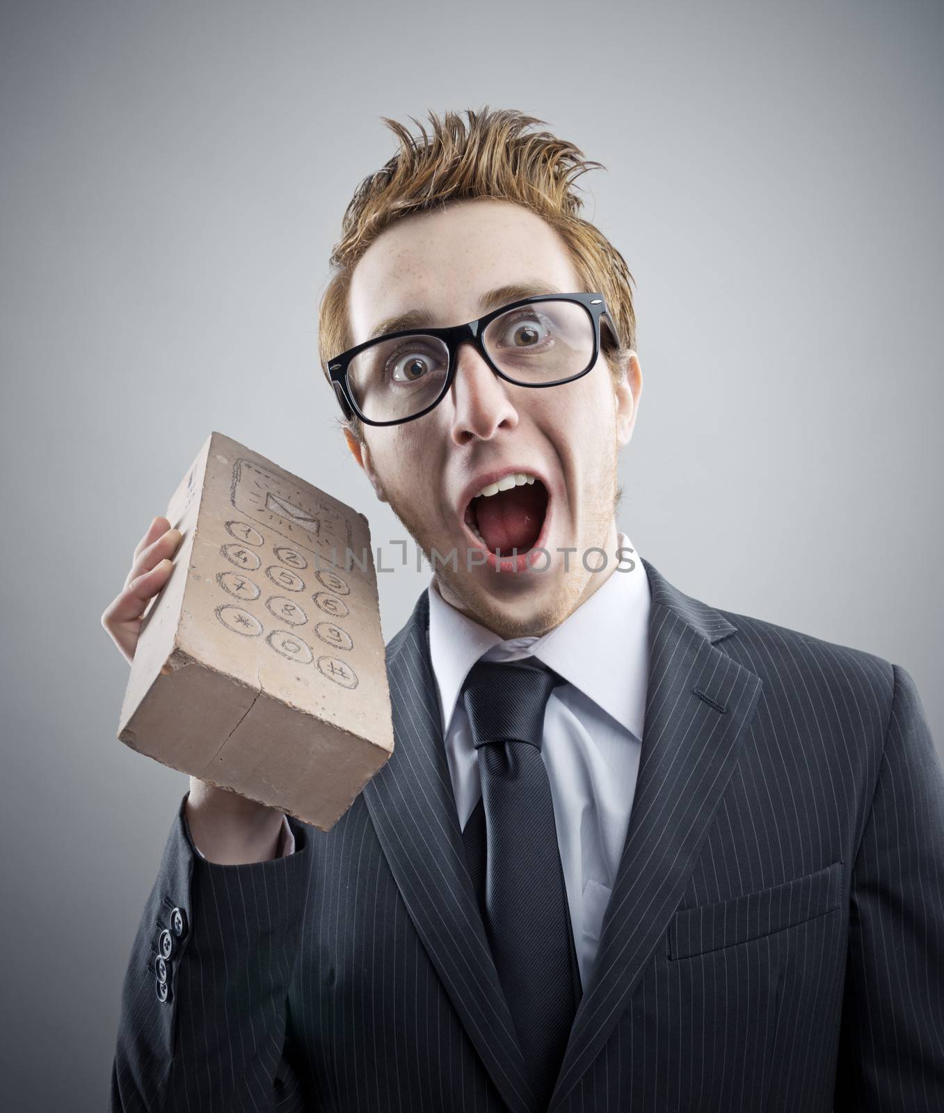 Portrait of mad Nerdy businessman with a unusual cell phone