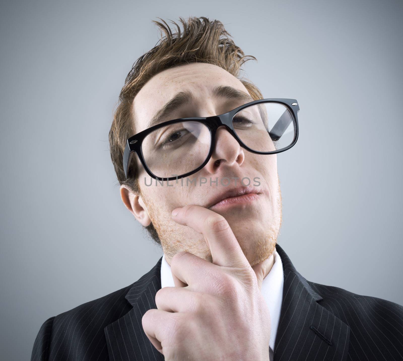 Portrait of young Nerd businessman looking at camera