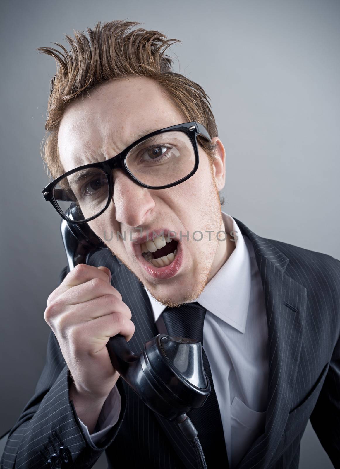Angry nerd businessman retro telephone call shouting