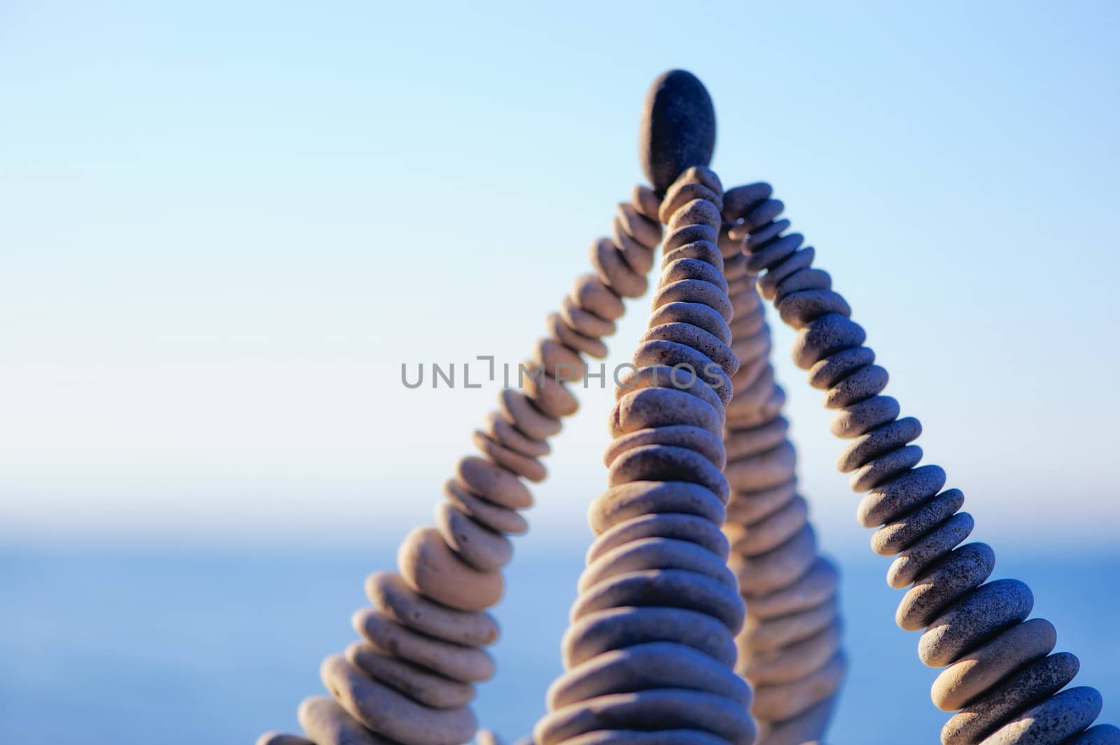 Pyramidal group of small pebbles in the balance on the seashore