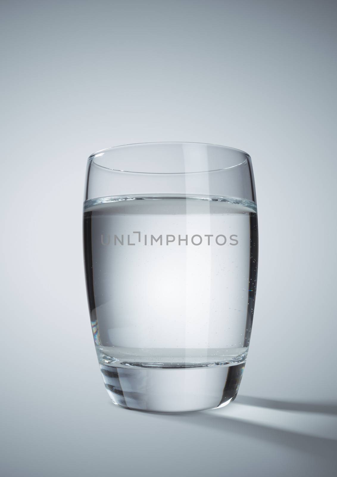 Glass of clear water on grey background