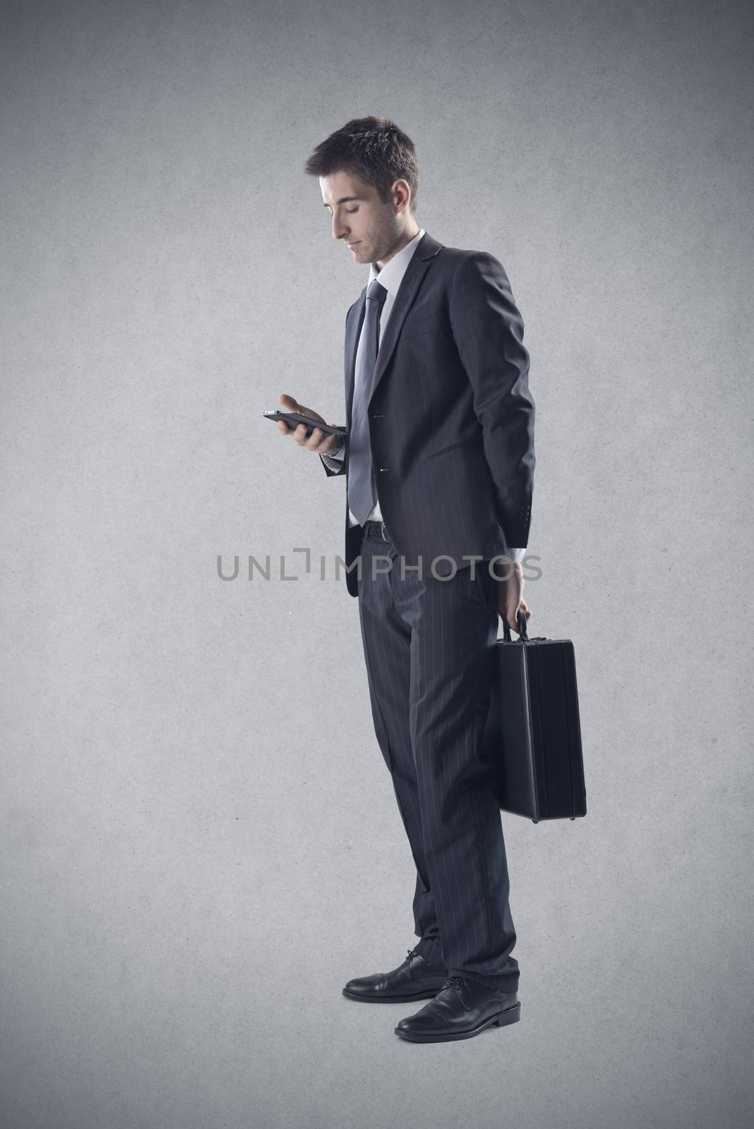 Businessman using a smartphone by stokkete