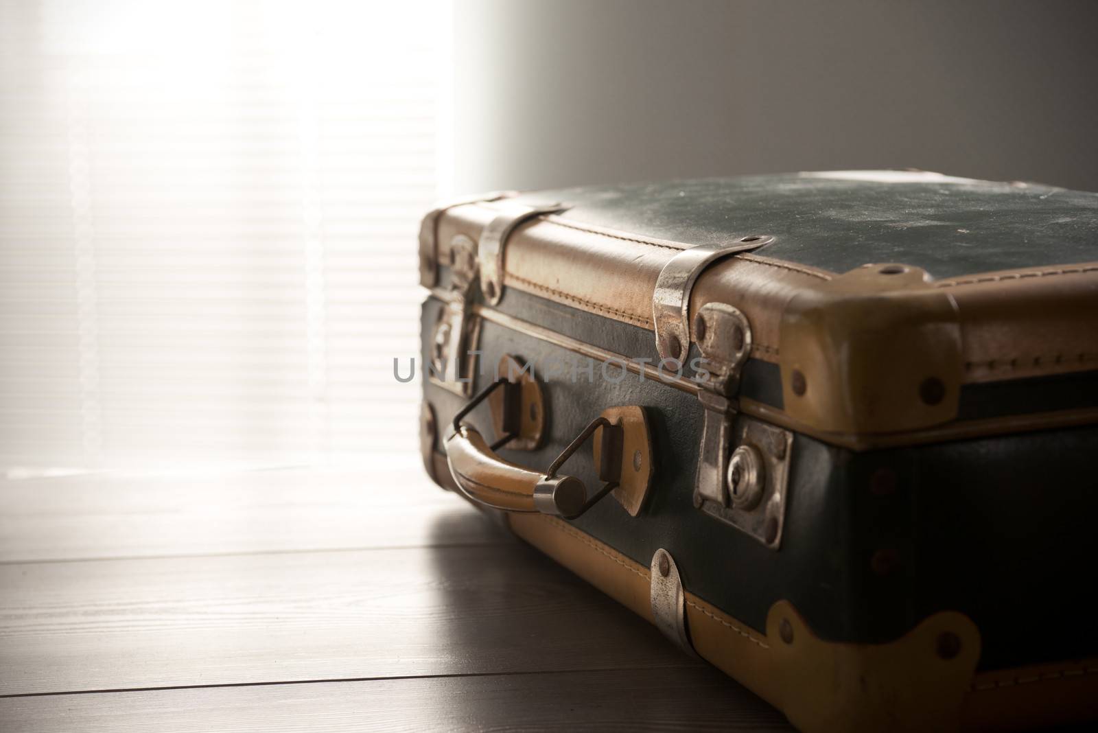 Vintage suitcase on a table, travel concept.