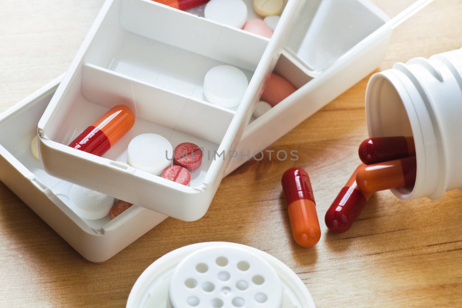 Daily medication - pills and capsules sorted out in pillboxes