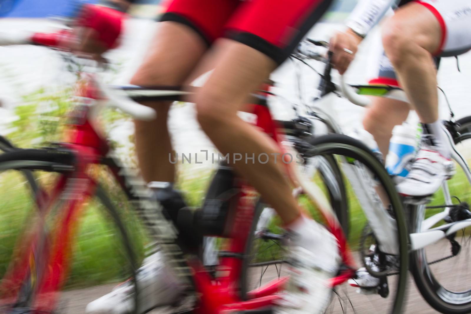 Racing cyclists at high speed by Colette