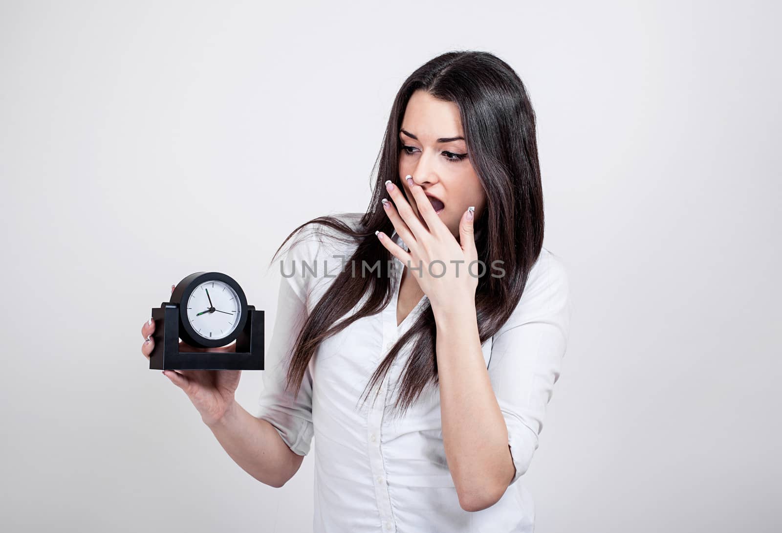 Beautiful attractive casual young woman with clock