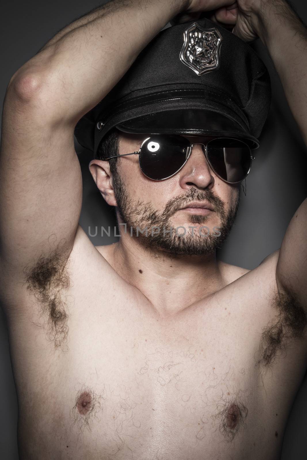 Nude, Good looking policeman, sexy police with sunglasses over dark background