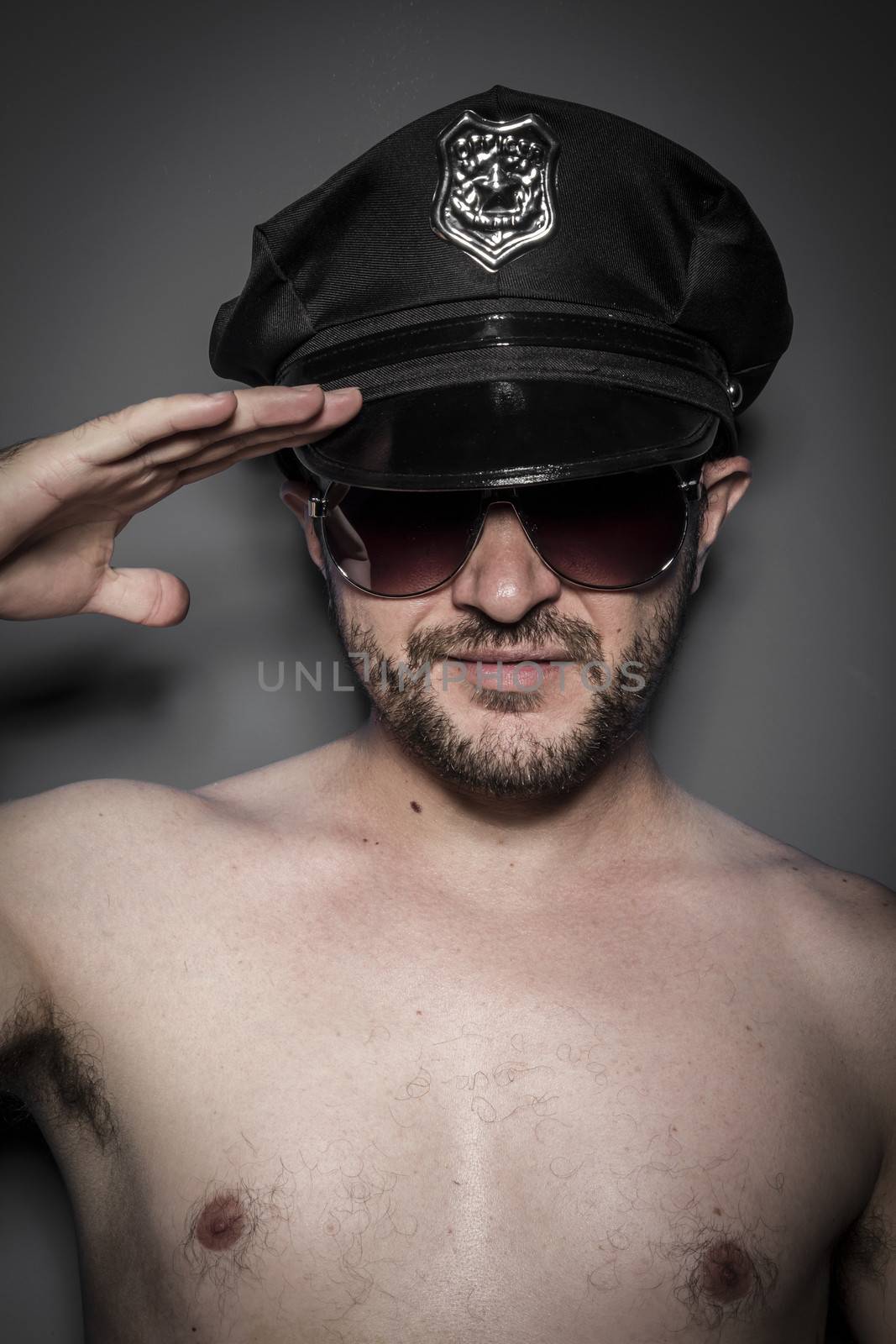 Good looking policeman, sexy police with sunglasses over dark background