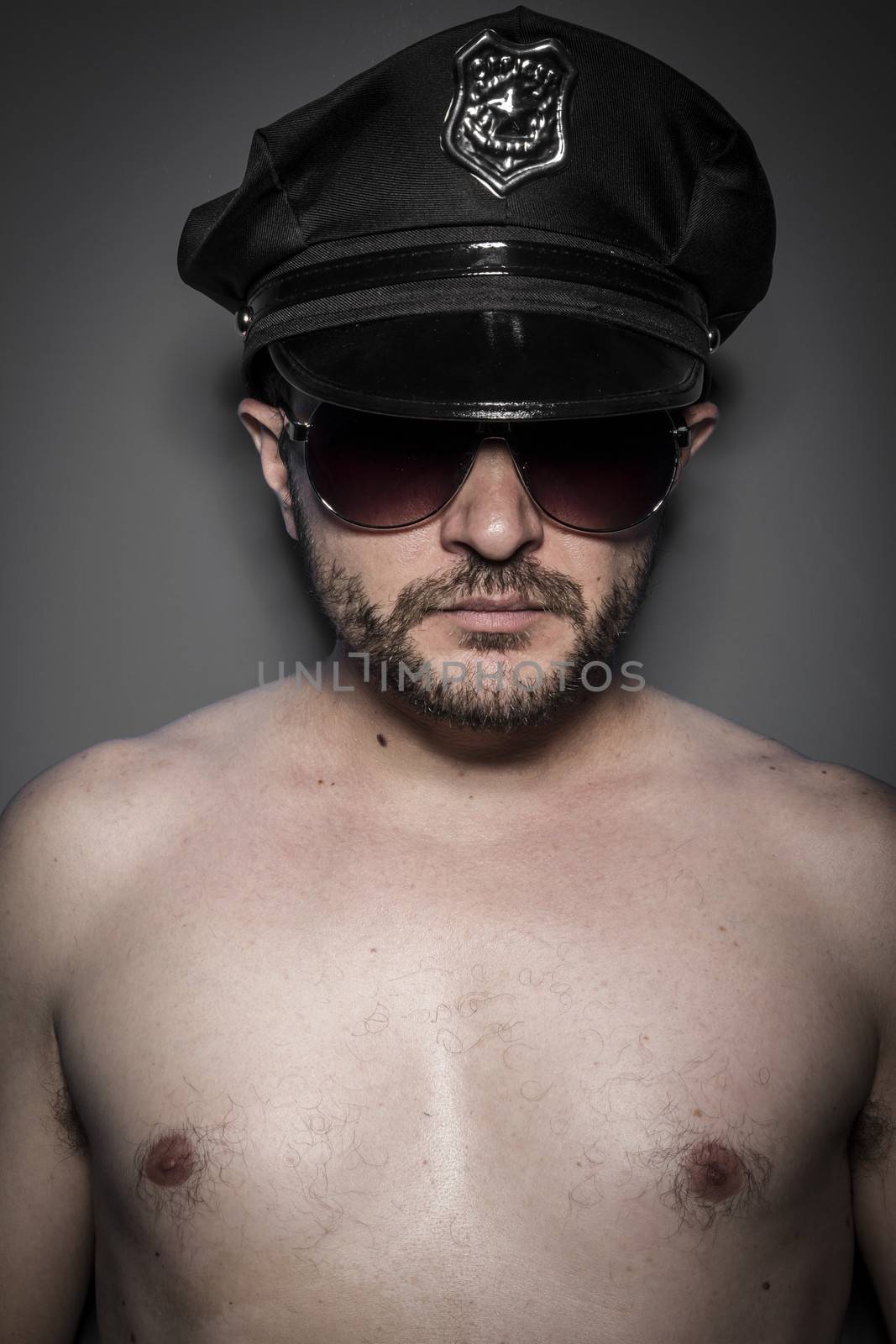 Good looking policeman, sexy police with sunglasses over dark background