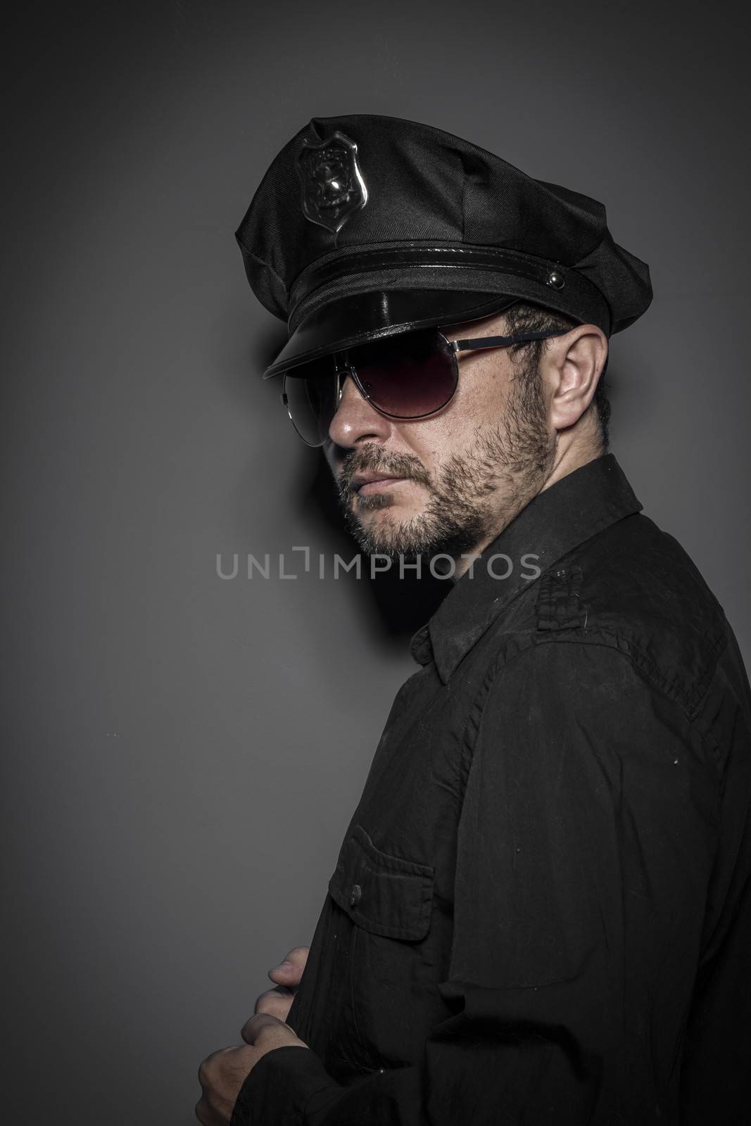 Criminal, Good looking policeman, sexy police with sunglasses over dark background