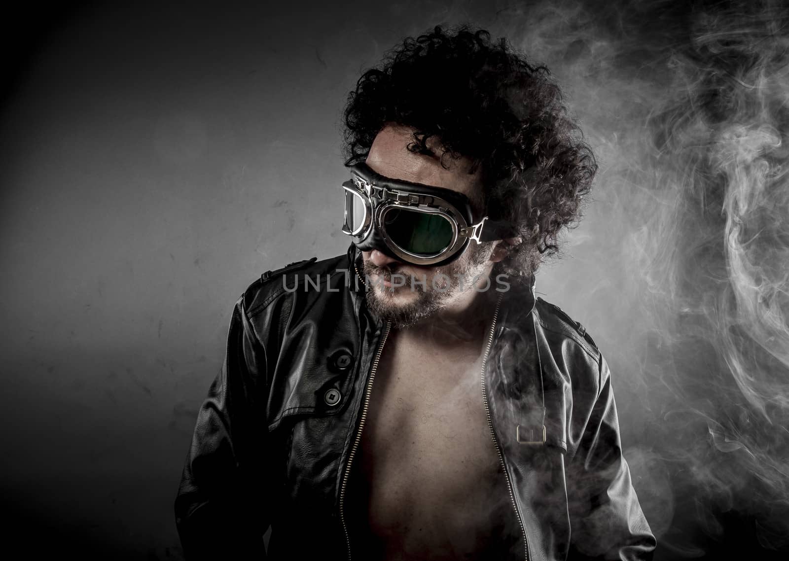 Sexy biker with sunglasses era dressed Leather jacket, huge smoke over dark background