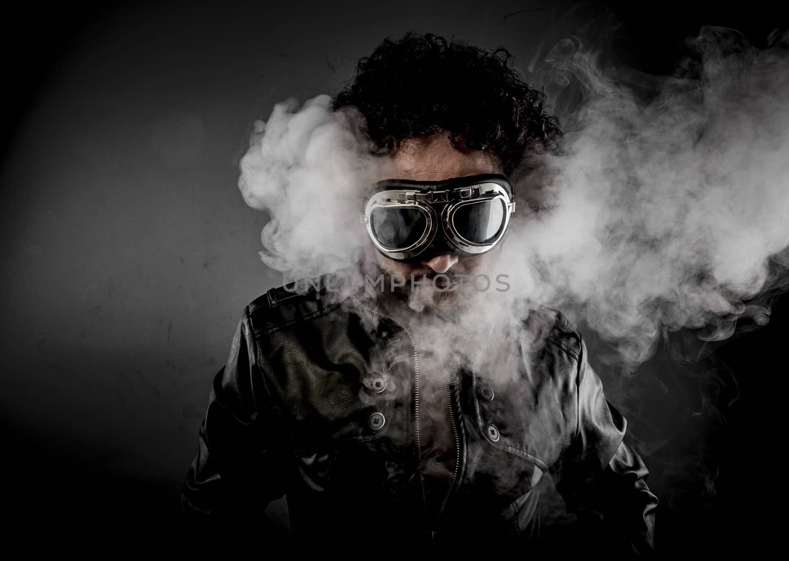 Power, biker with sunglasses era dressed Leather jacket, huge smoke over dark background
