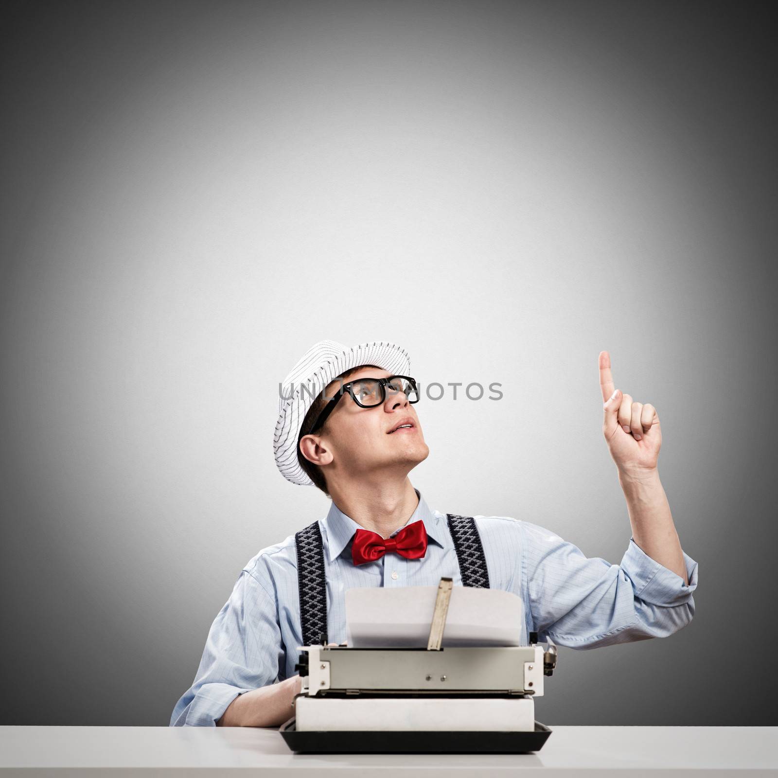 image of a young journalist, sitting at the table for a typewriter