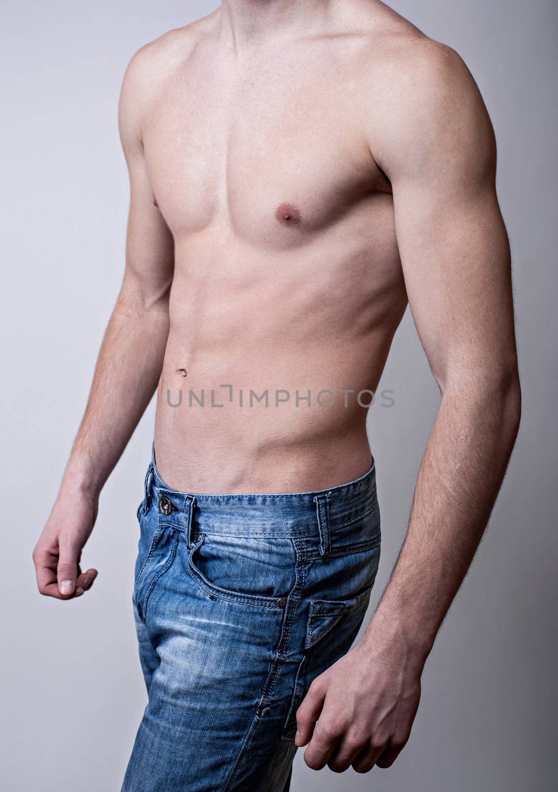 Handsome muscular young man. Shot in a studio.