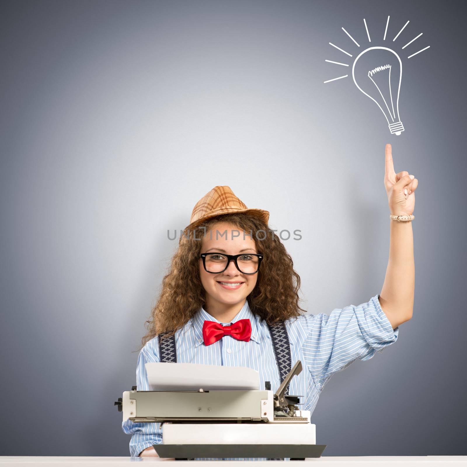 image of a young woman writer at the table with typewriter