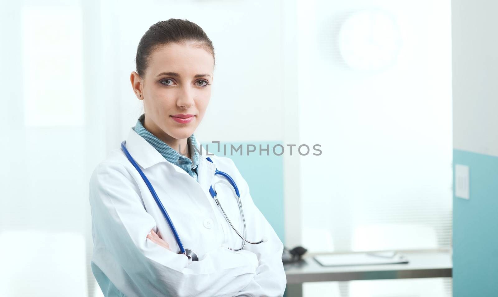 Portrait of a female doctor standing with arms folded 