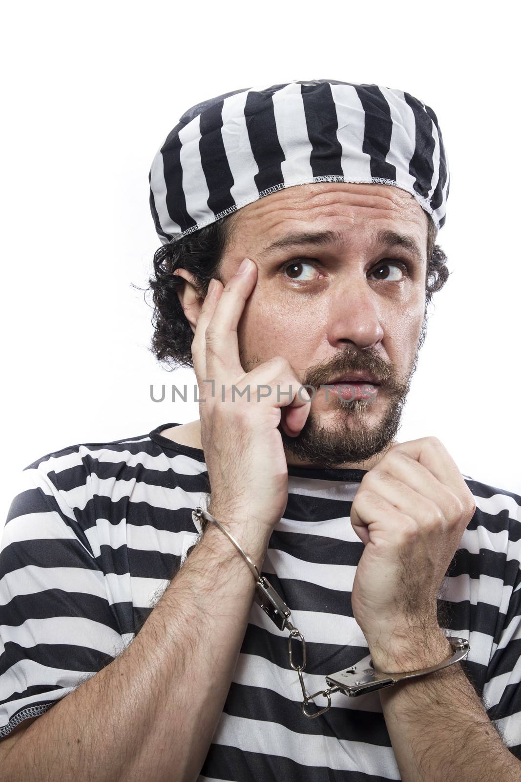 Desperate, portrait of a man prisoner in prison garb, over white background